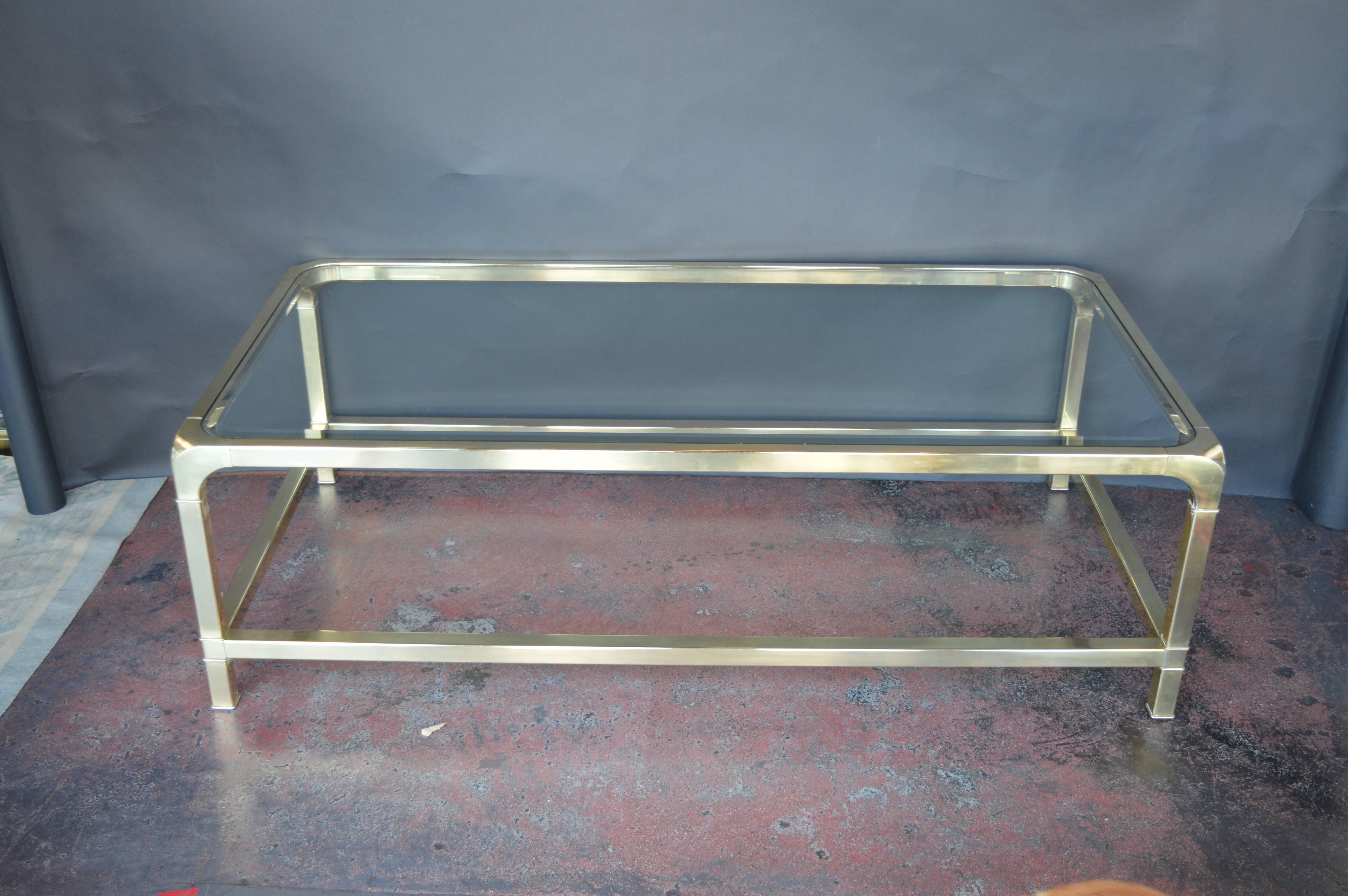 Brass mastercraft coffee table with bevelled glass top.