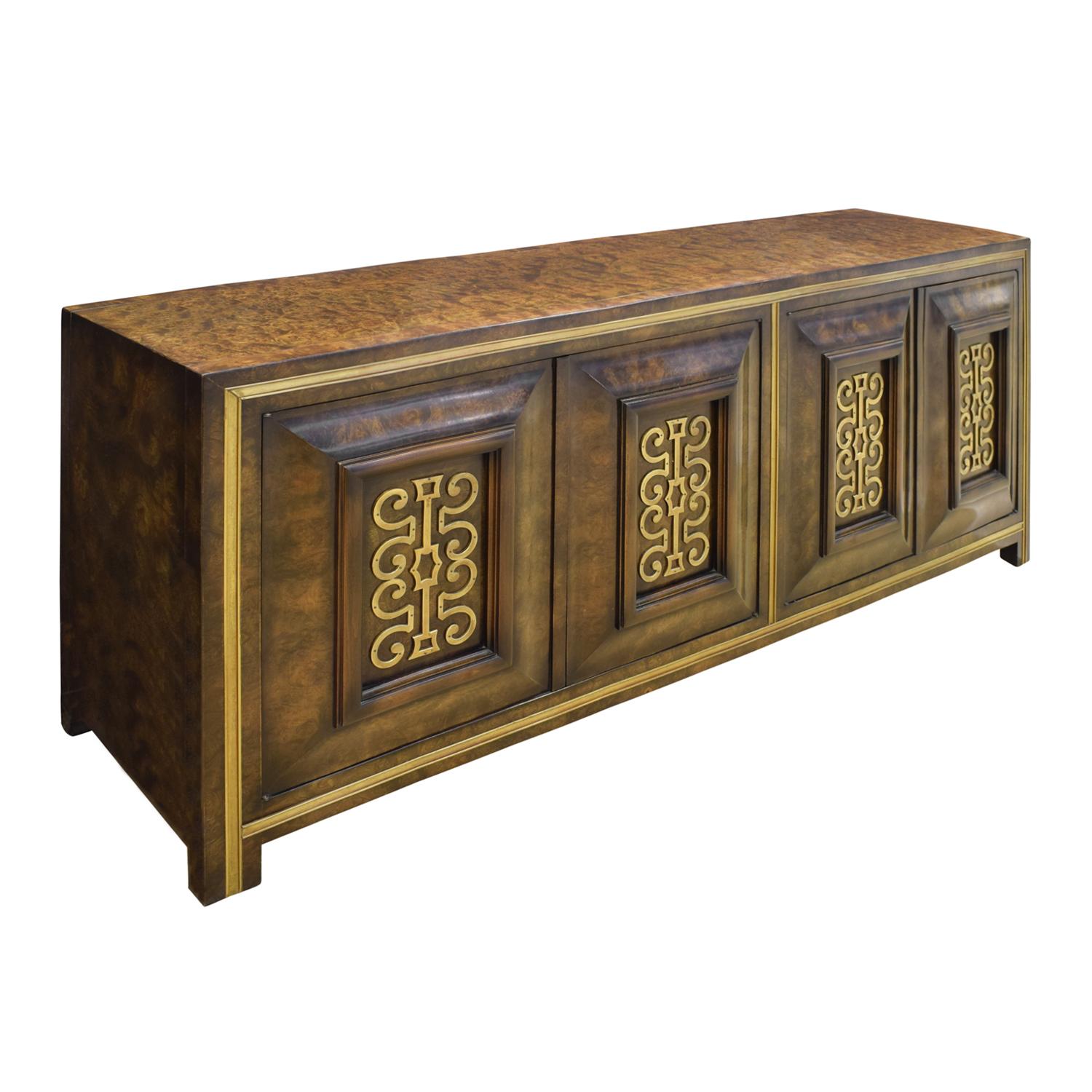 Beautifully crafted credenza in book-matched Carpathian elm with stylized brass decoration on every door and brass trim by Mastercraft, American 1960s. The stylized brass decoration on the doors is exquisite.