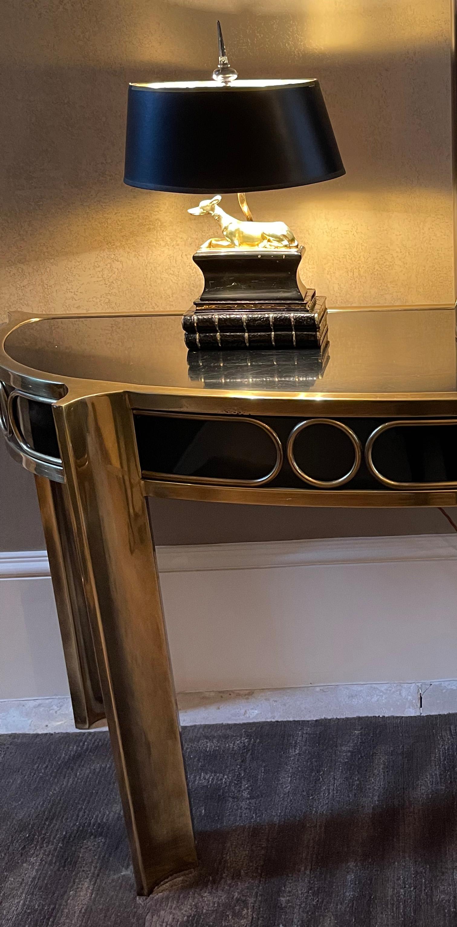 Black lacquer and polished brass demilune console table by Mastercraft. 

Stunning example of their work from the 1970s. This piece is signed.