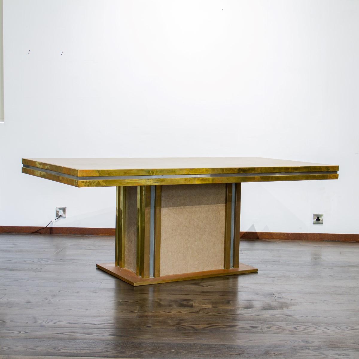 A brass and leather dining table designed by Mastercraft with aluminium strips breaking up the brass, 1970s.

Mastercraft is synonymous with high style and high society living from mid to late 20th century. The American based company created