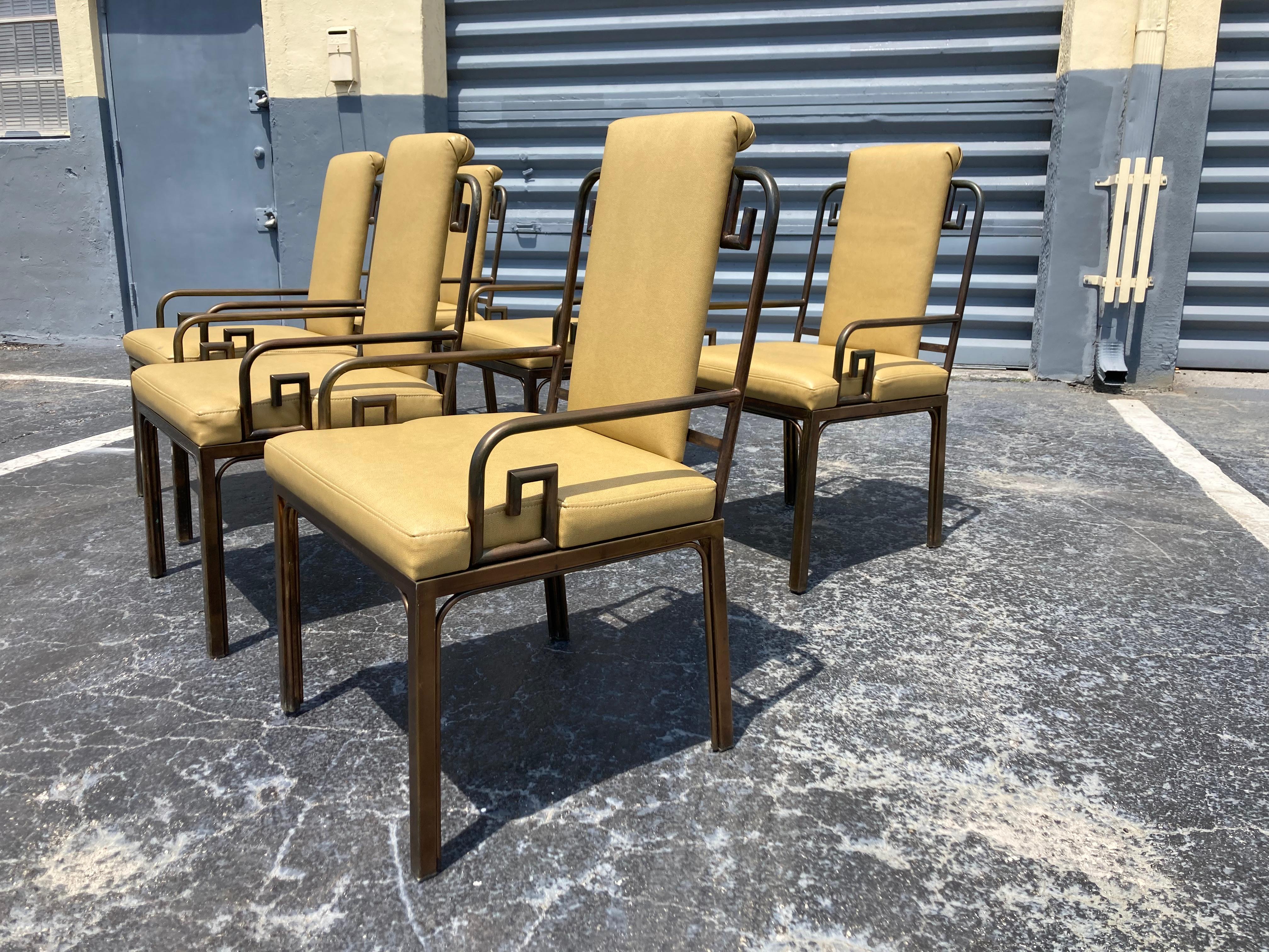 Mastercraft dining chairs with greek key design.The Uphostery is vinyl and the chairs have a brass plating/finish. In total 12 chairs available.