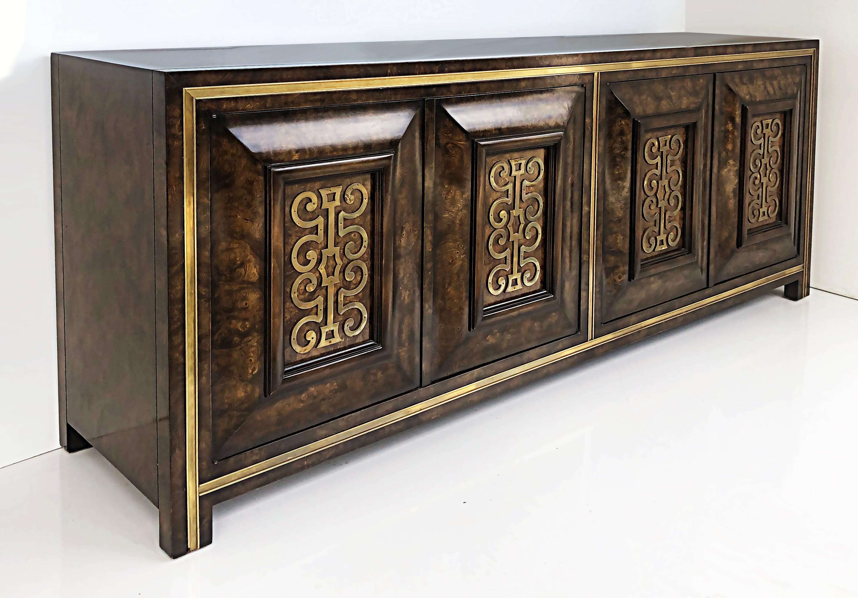 Mastercraft elm and brass credenza by William Doezema, 1970s

Offered for sale is a 1970s Mastercraft Furniture Co. Carpathian Elm and brass mounted credenza designed by William Doezema. The cabinet has four doors with touch release latches that