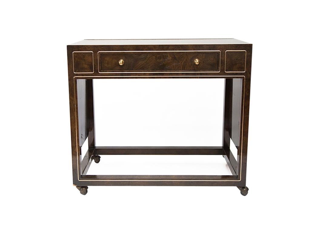 A superbly crafted bar cart made of exotic Carpathian elm with an acid etched bronze surface and brass inlays by Mastercraft. The sides raise to provide an extended serving area. On casters. Extends to 76
