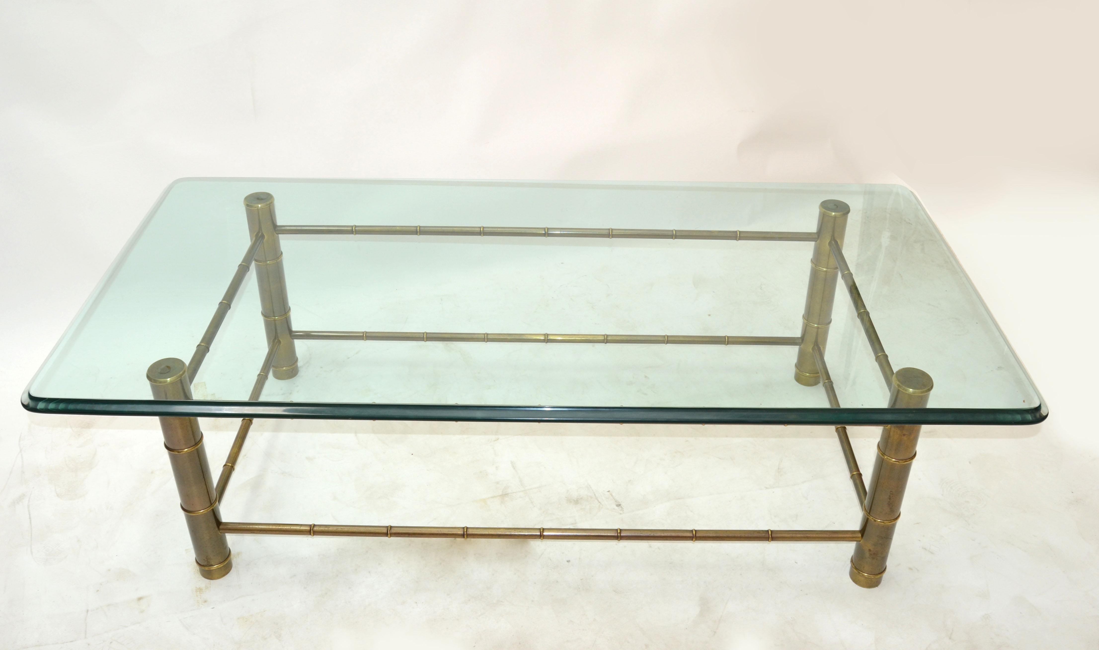 Incredible Mastercraft faux bamboo brass rectangular coffee table with heavy beveled and green tinted glass top.
Mid-Century Modern patinated brass faux bamboo with the original glass top.
Made in USA.
Base measures: 47.5 x 24.5 x 17 inches