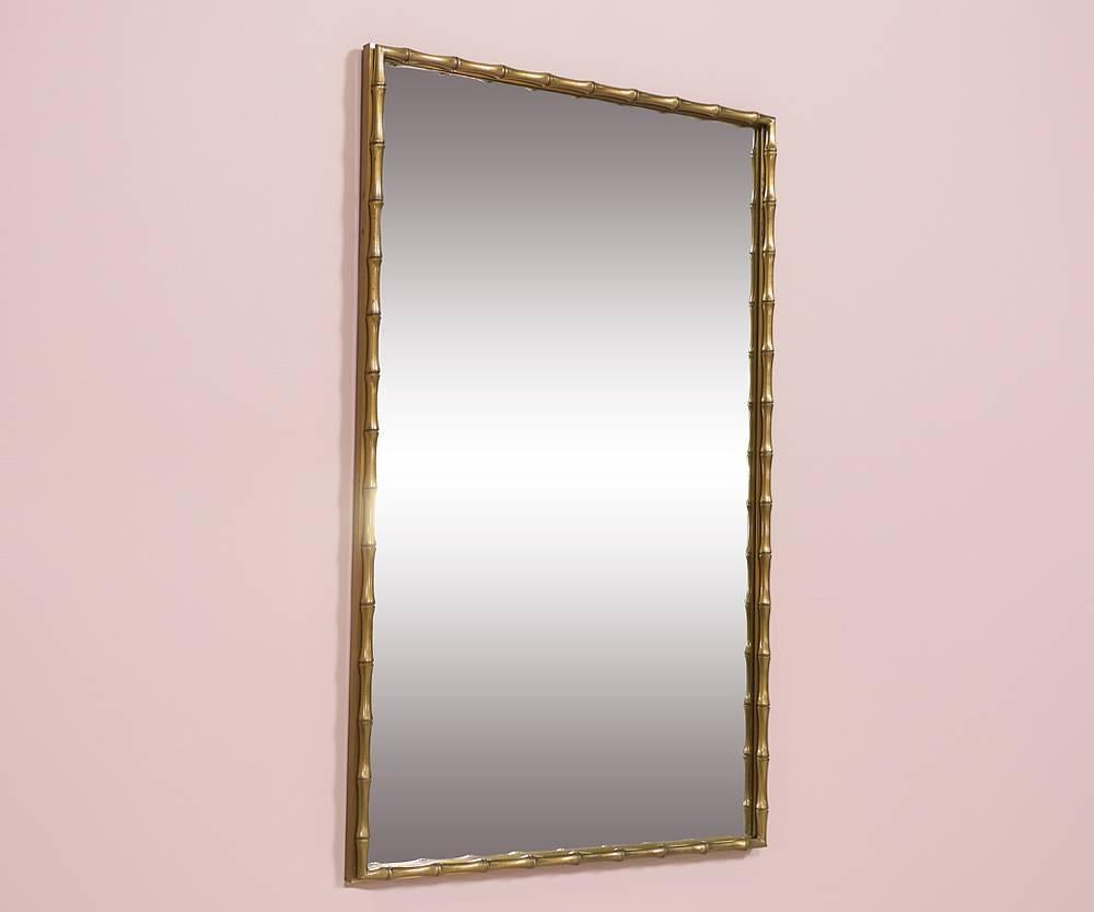 Elegant, 1970s brass faux-bamboo framed mirror by Mastercraft. The mirror’s understated elegance lends itself to be used in a variety of design themes from modern to traditional interiors.