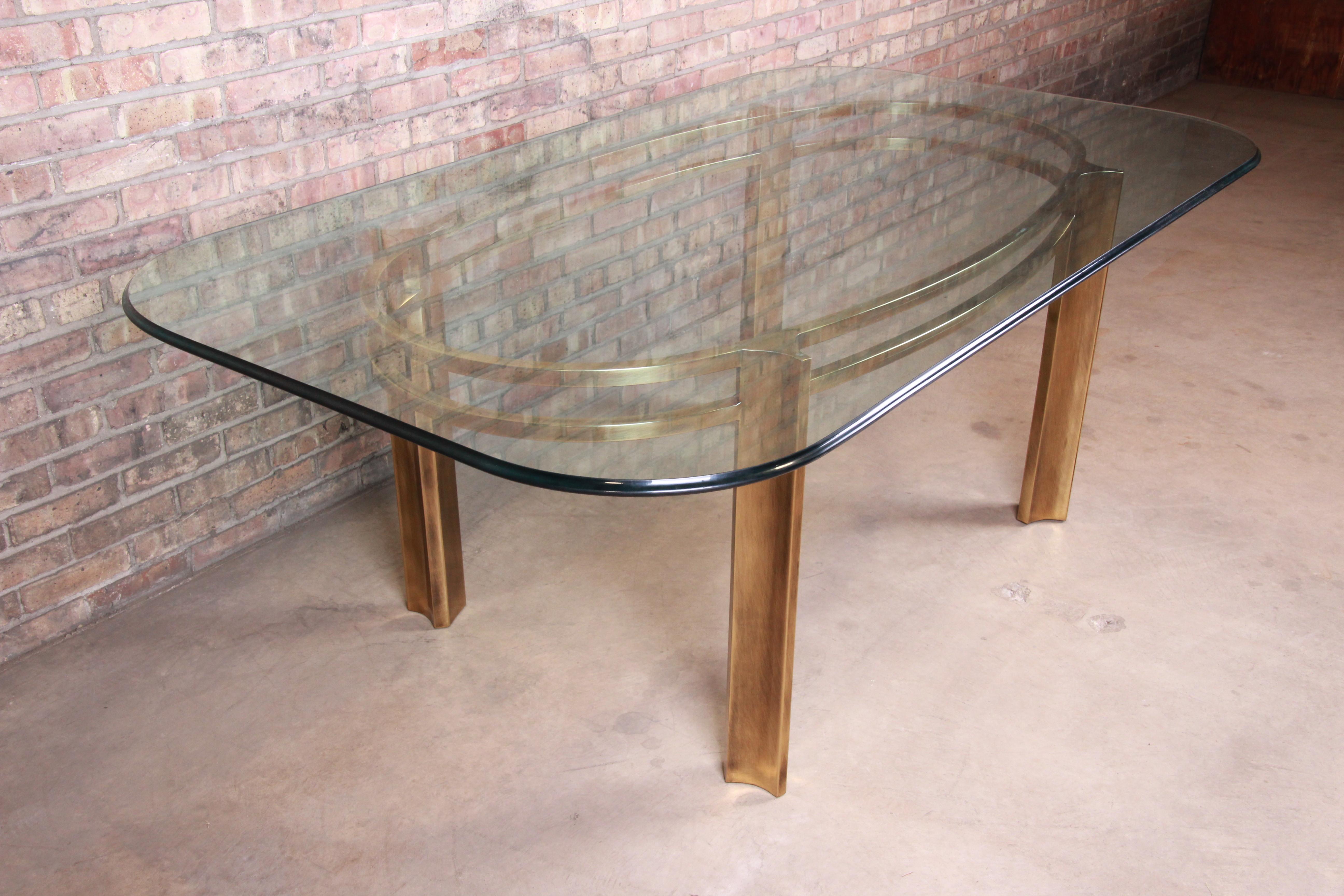 An exceptional midcentury Hollywood Regency dining table

Produced by Mastercraft for Baker Furniture

USA, 1970s

Brass base with thick beveled glass top.

Measures: 80