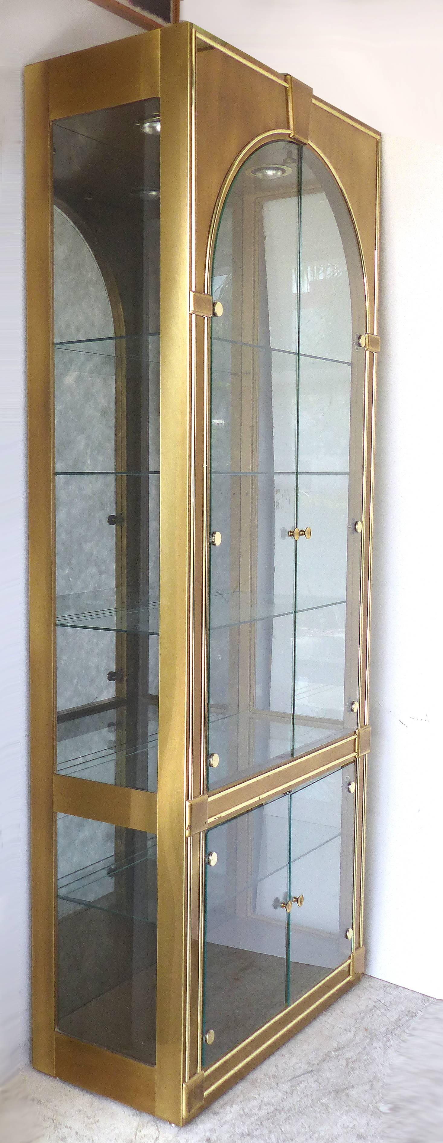 Mastercraft Furniture Brass & Glass Cabinet with Domed Glass Doors & Aged Mirror

Offered for sale is a nice Mastercraft brass and glass display cabinet with glass shelves, two domed glass and interior lights. This beautiful classically designed