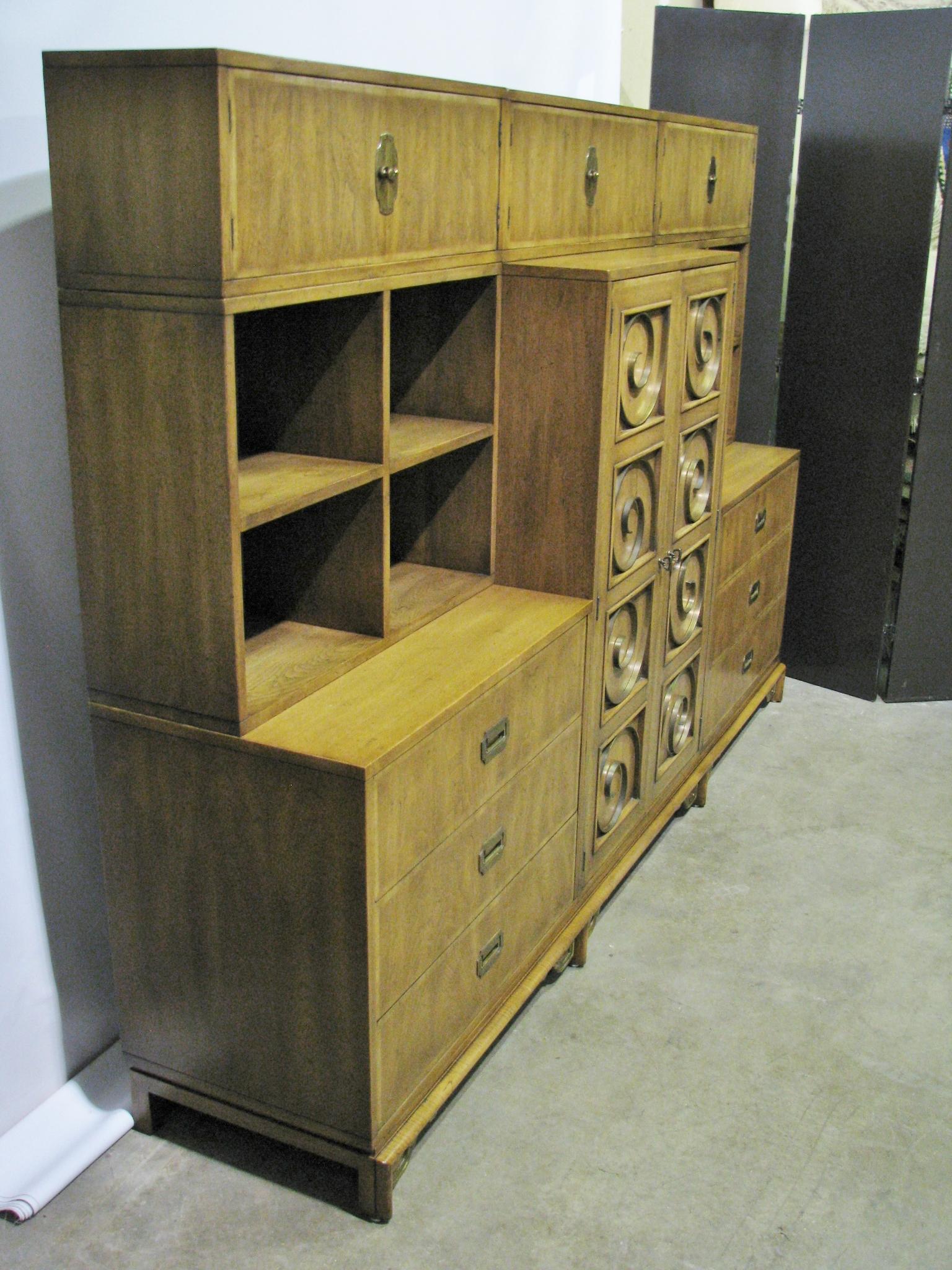 Unique and rare 1960s, nine-piece wall unit by Mastercraft from the midcentury period. A single base allows for the 8-pieces to be configured in various ways using all or just a selection of the components. The feet have an Asian-inspired motif,