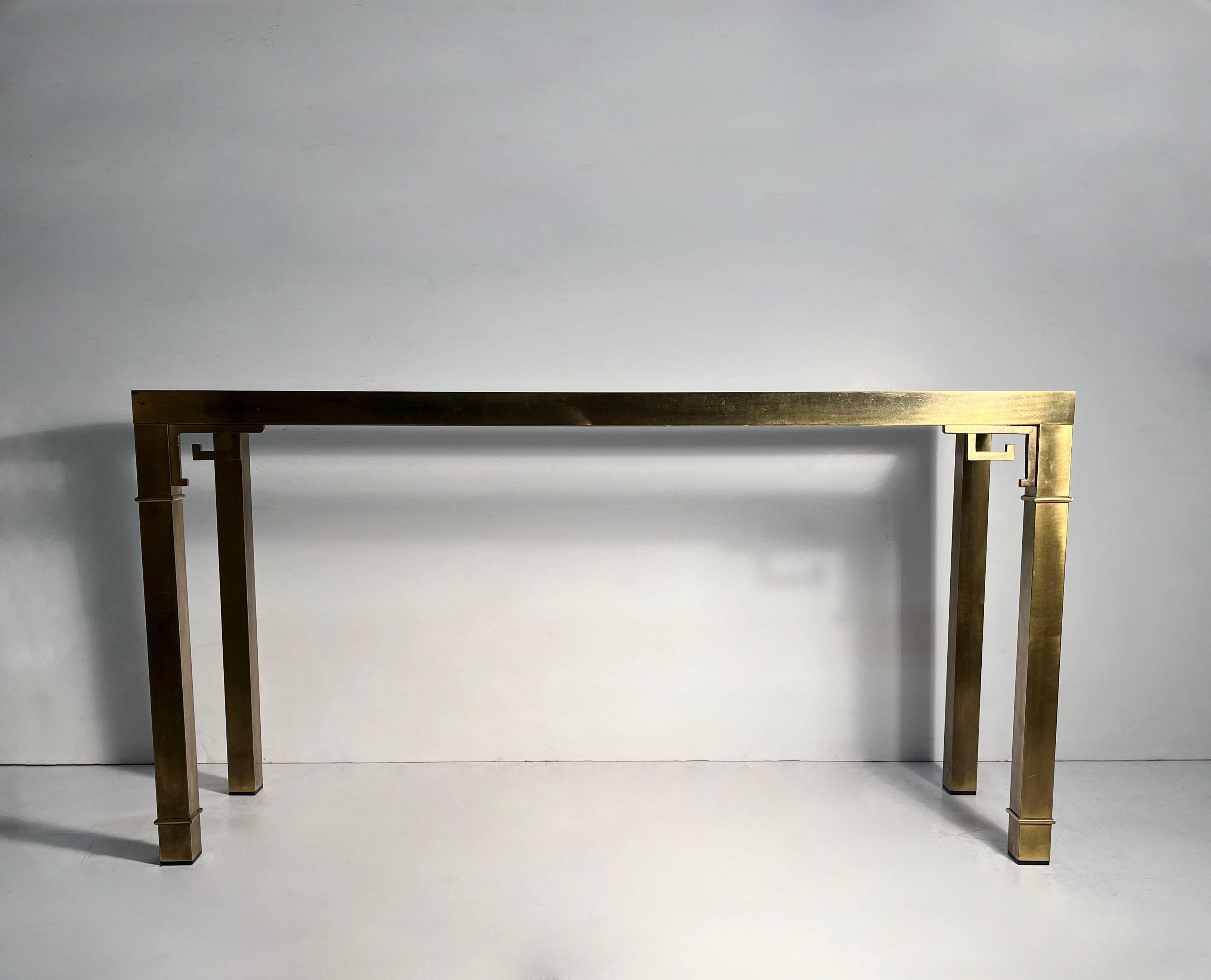 Greek Key Brass and Glass Console by Mastercraft. Made in Italy. This console is period 1970s and is designed to be positioned against a wall or sofa.

Structurally Sound. The original brass finish shows plenty of wear and age along with patina.