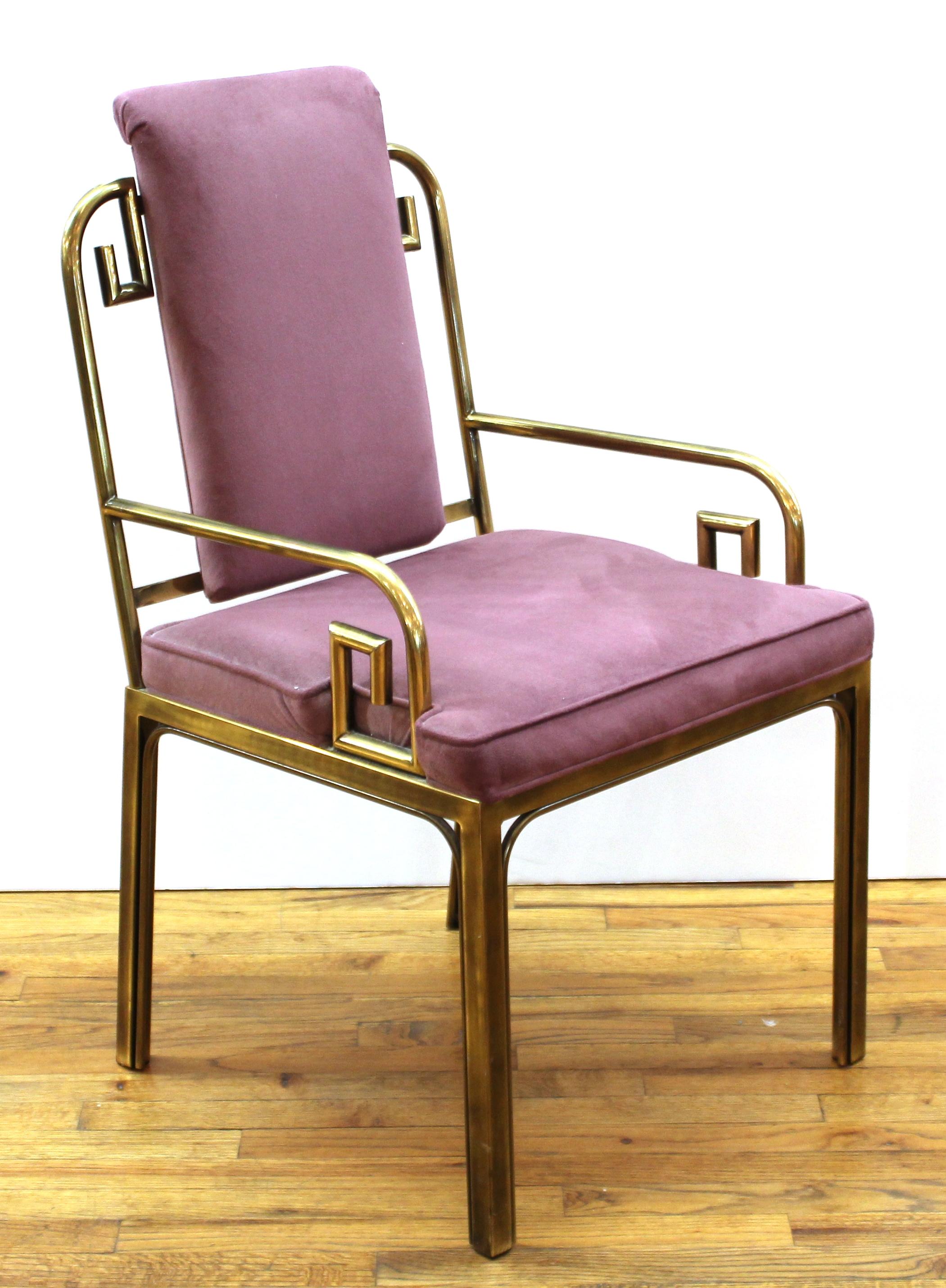 Mastercraft Modern Hollywood Regency pair of brass Greek key side chairs or dining chairs, made during the 1970's in the United States. The pair has new upholstery and is in great vintage condition with age-appropriate wear and use.