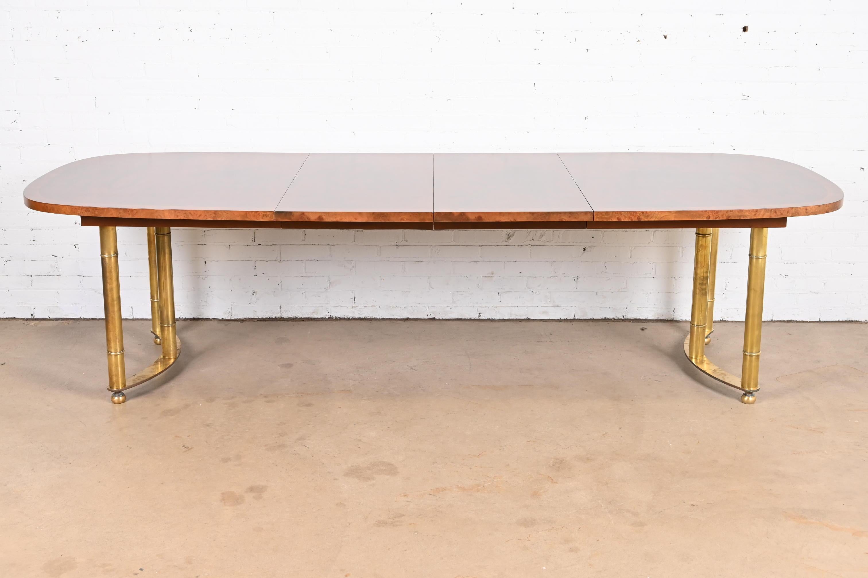 An exceptional mid-century modern Hollywood Regency extension dining table

By Mastercraft

USA, 1970s

Gorgeous book-matched burled walnut top, with burled olive wood banding, and brass pedestals.

Measures: 72