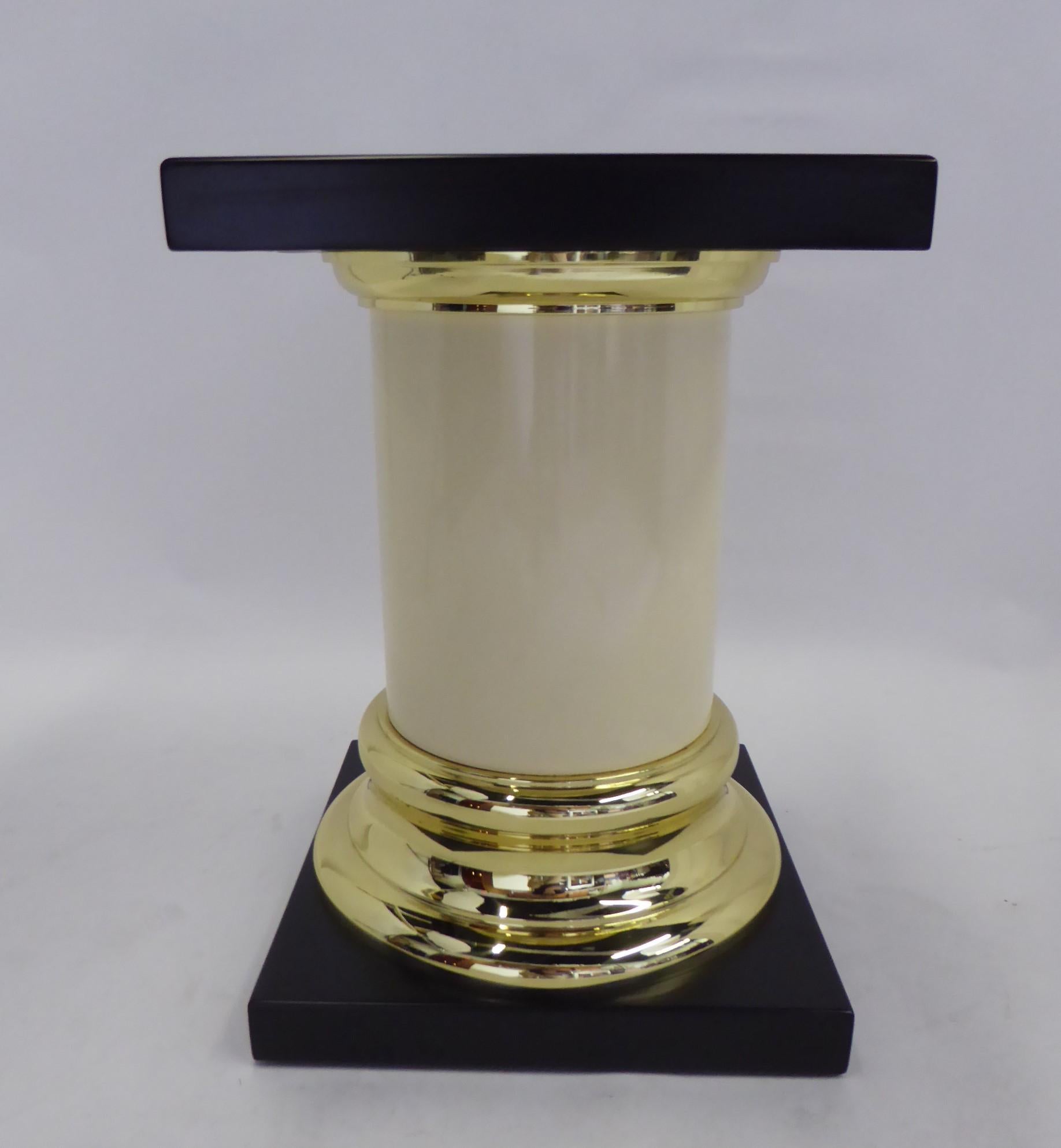 A Mid-Century Modern Mastercraft pedestal or side table with a simple Roman Tuscan column design. Featuring a smooth cylindrical ivory colored resin (or ABS plastic) shaft with solid brass capital and base terminating on both ends in a satin black