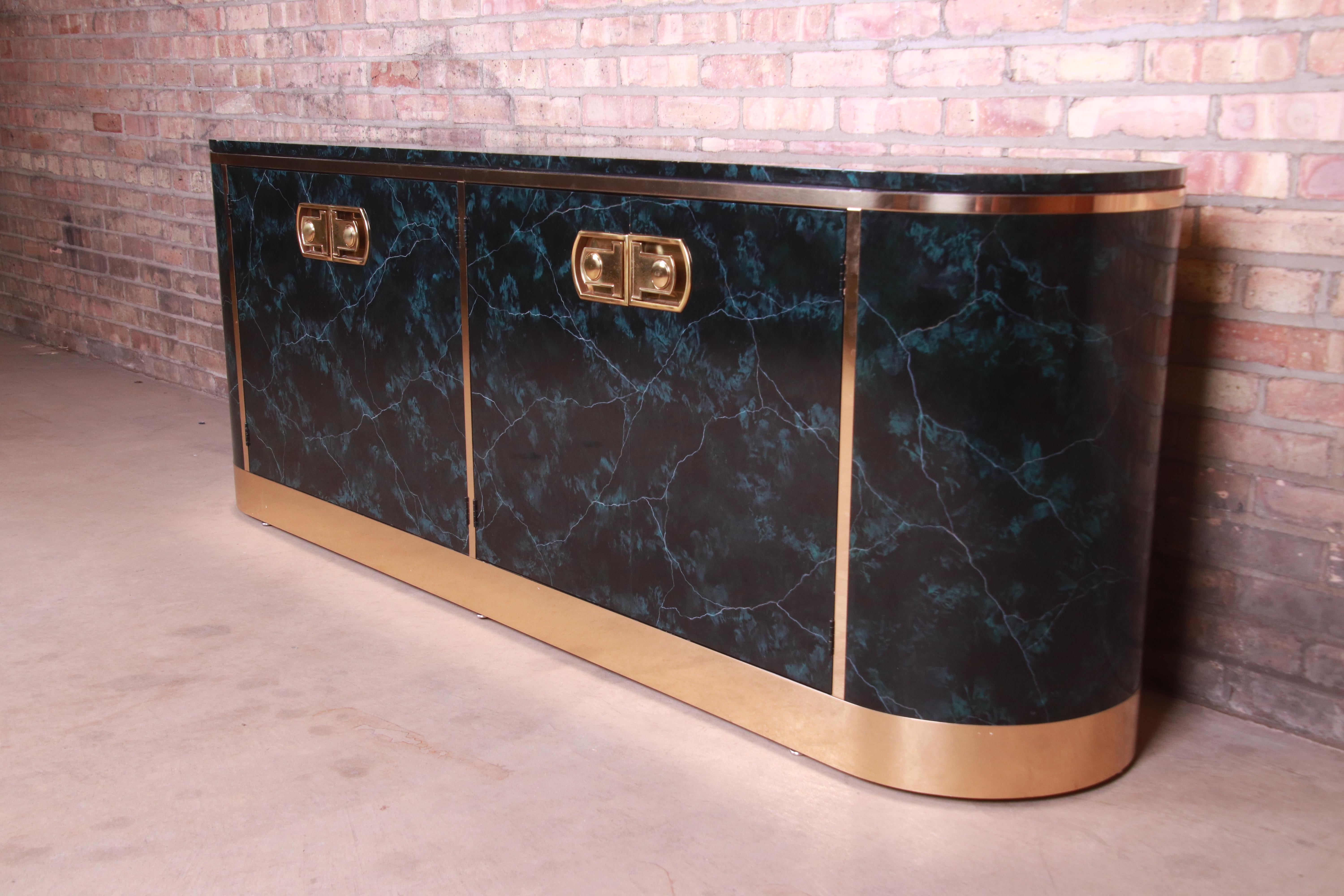 A gorgeous Mid-Century Modern Hollywood Regency sideboard, credenza, or bar cabinet

By Mastercraft

USA, 1970s

Lacquered faux green marble, with original brass mounts and hardware.

Measures: 80