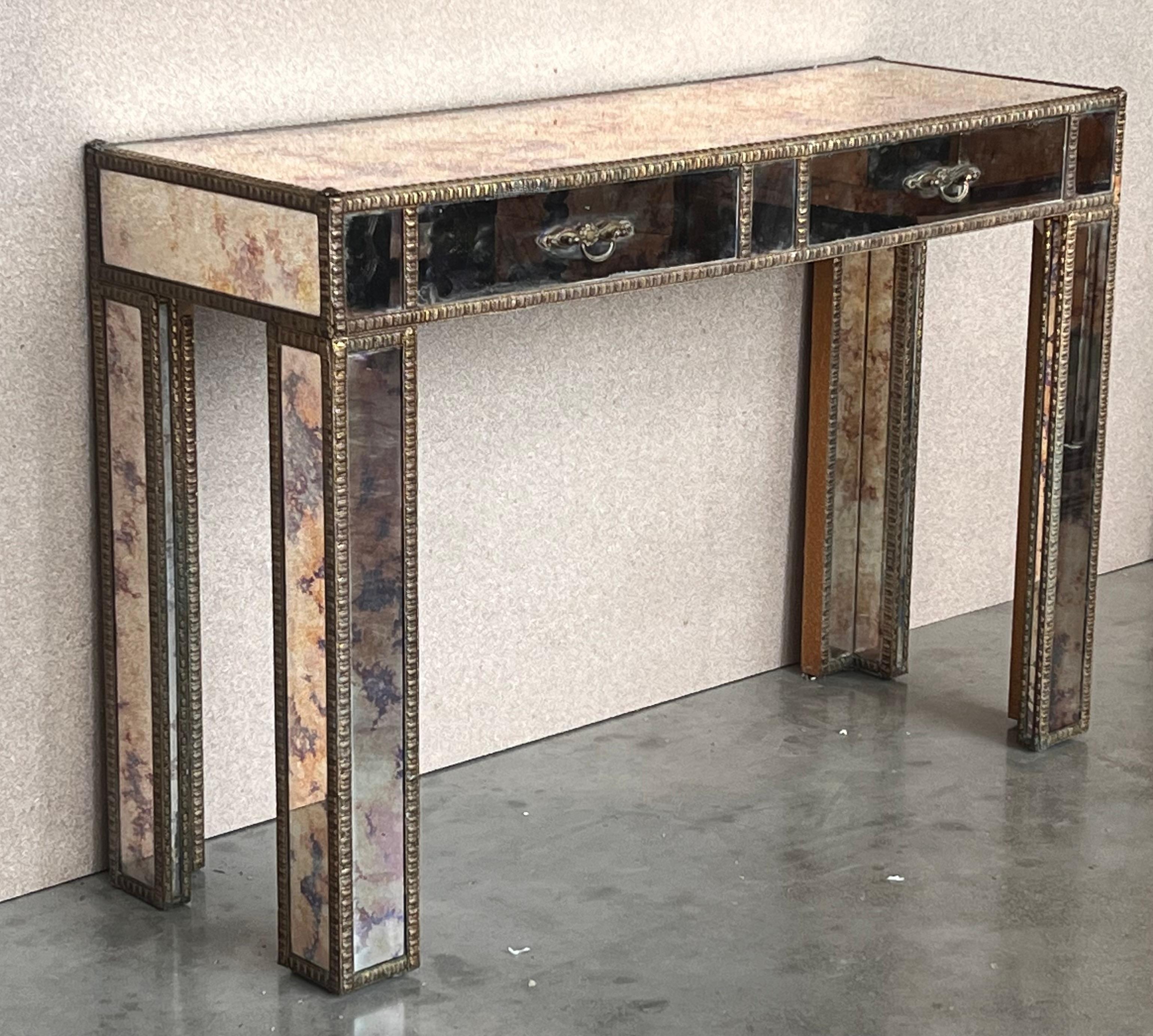 An exceptional Mid-Century Modern Hollywood Regency console table 
Brass frame with filigrees, and inset pink mirrored glass top. 

 Good original vintage condition.