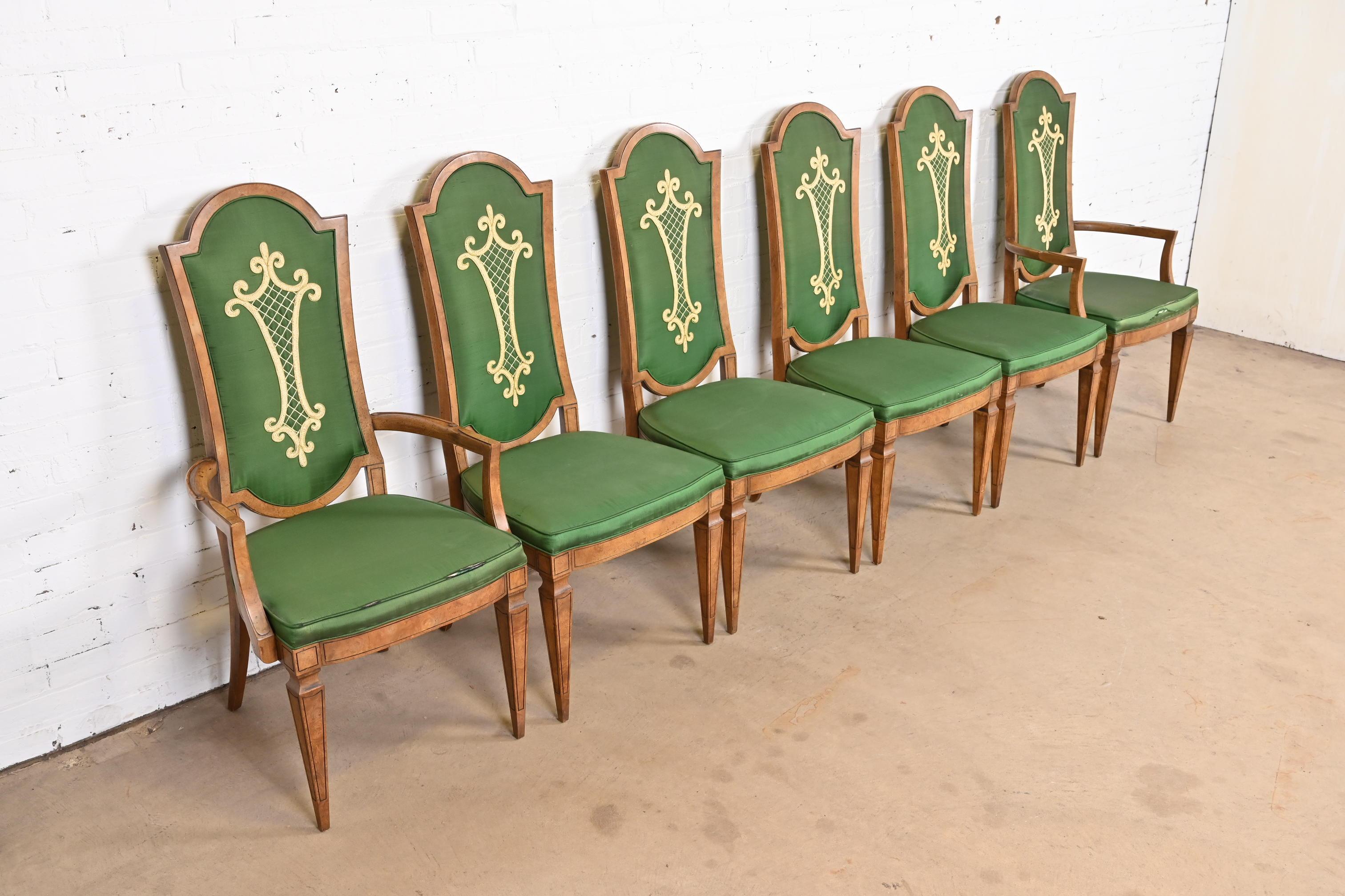 A gorgeous set of six Italian Regency or Louis XVI style dining chairs

By Mastercraft

USA, circa 1960s

Burled olive wood frames, with green upholstered seats and backs with gold embellishments.

Measures:
Side chairs - 19.75