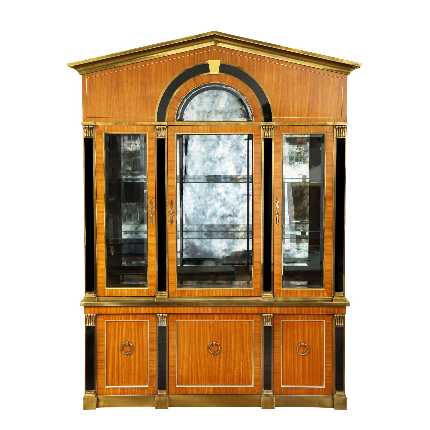 Stunning large illuminated Neoclassical display cabinet in bronze and mahogany with black granite on front and antique glass on back wall of top section of cabinet with glass shelves by Mastercraft, American 1960s.  The quality of the construction