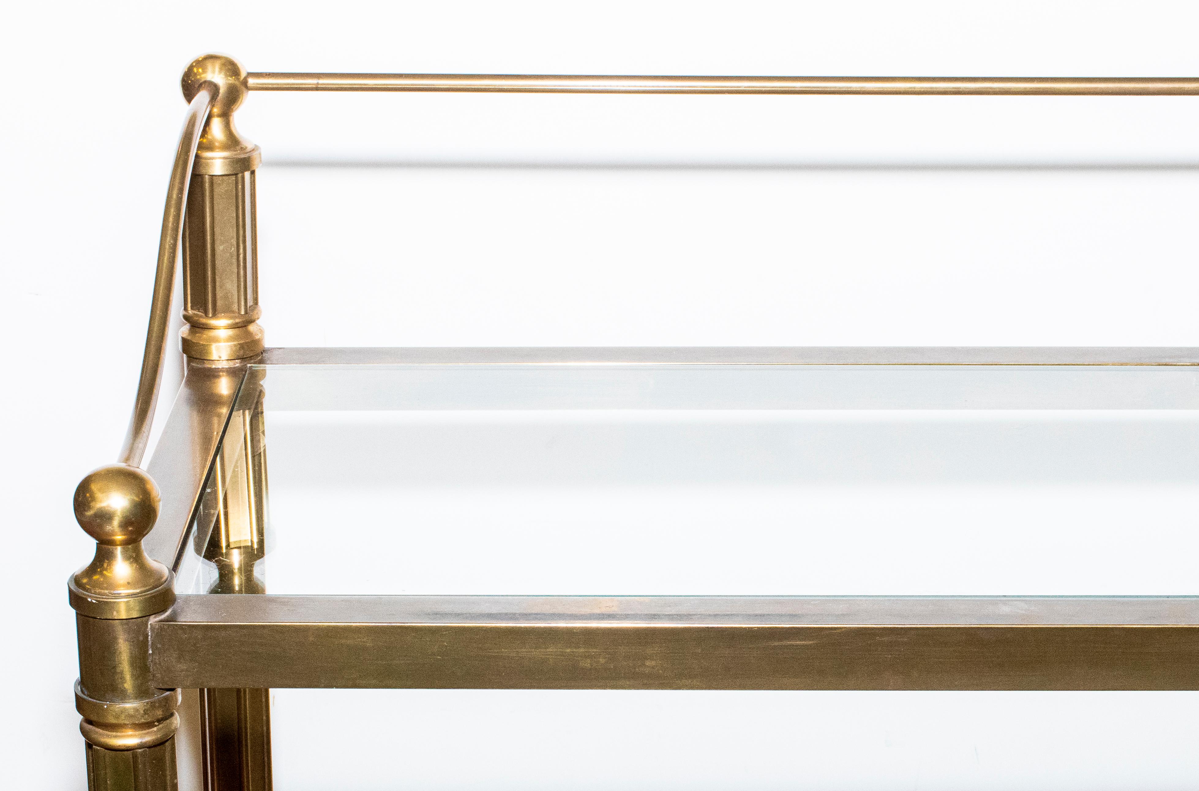 Beautiful Mastercraft metal and brass 3-tier low etagere or bookcase. Piece has 3  glass shelves.
