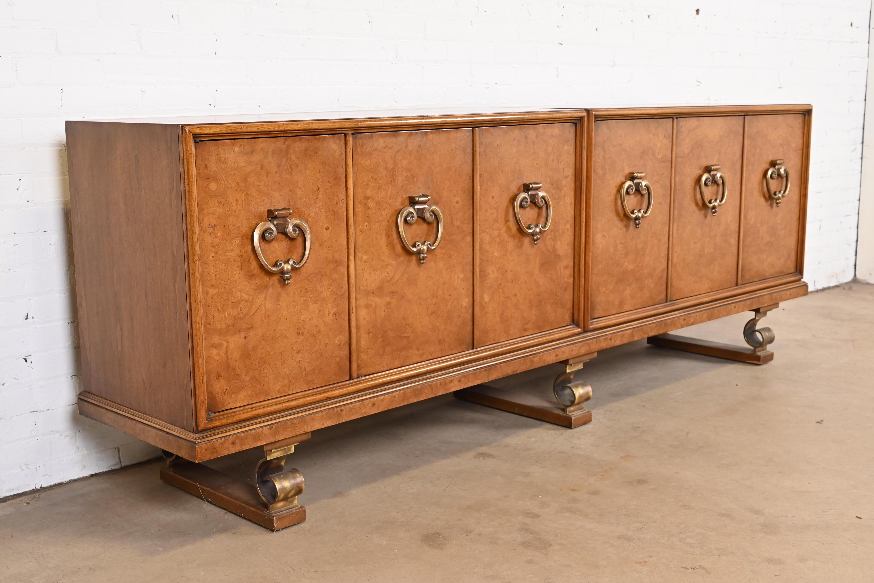 A gorgeous monumental mid-century modern Hollywood Regency sideboard, credenza, or bar cabinet

By Mastercraft

USA, Circa 1960s

Beautiful burled olive wood, with fruitwood case, original brass hardware, and scrolled brass legs.

Measures: 99.5
