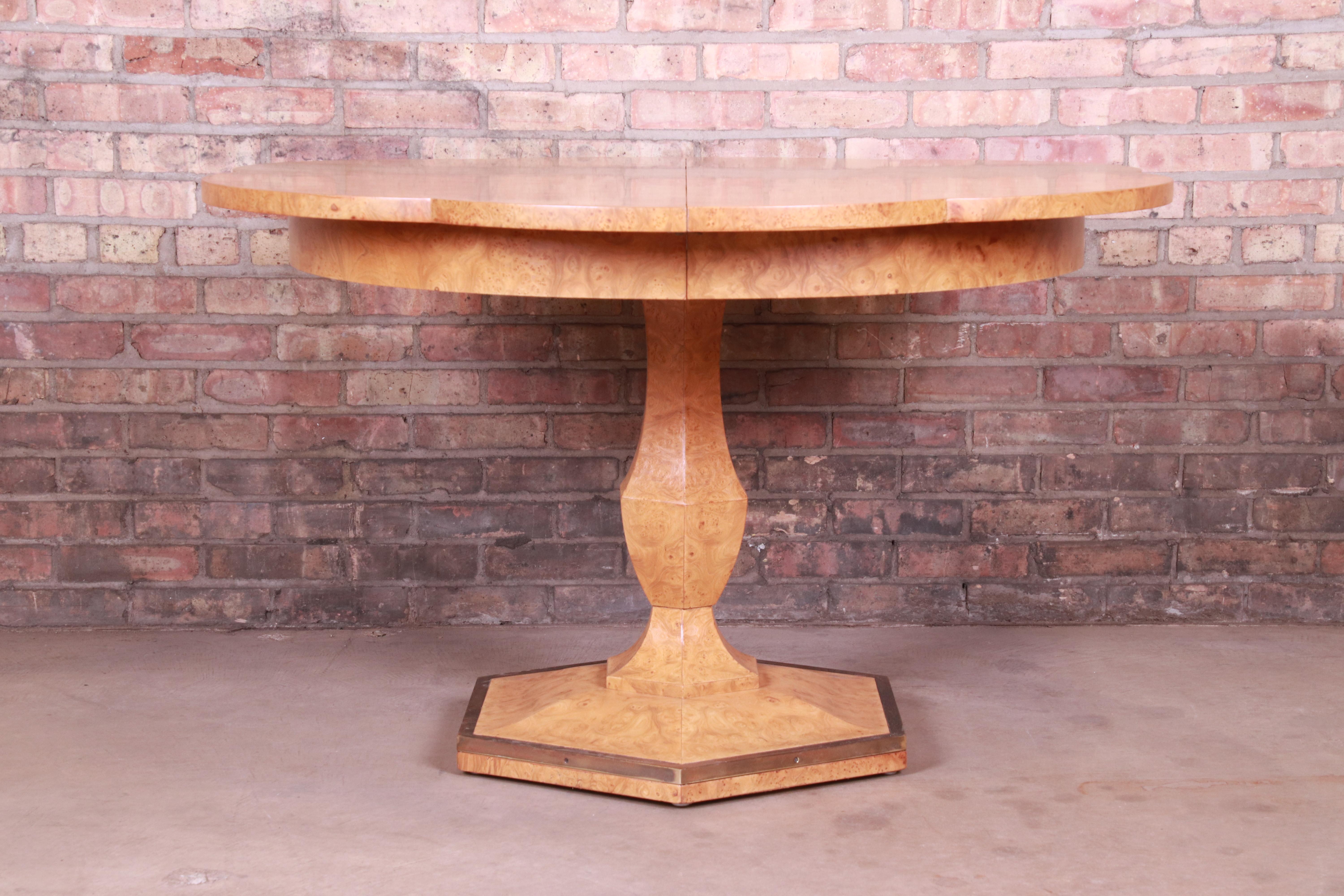 An exceptional Mid-Century Modern Hollywood Regency extension pedestal dining table

By Mastercraft

USA, circa 1960s

Olive ash burl wood, with brass accents.

Measures: 45.63