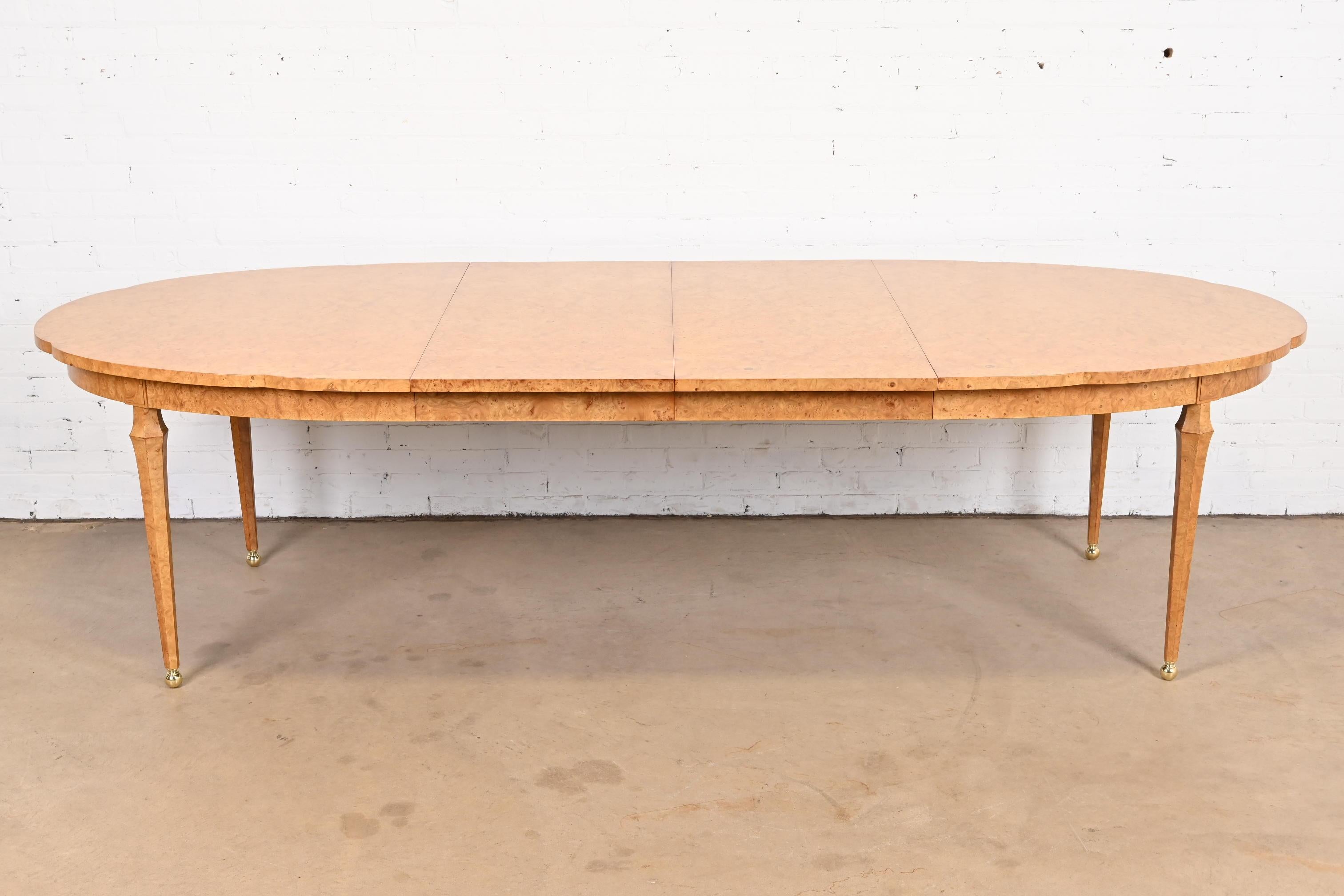 An exceptional Mid-Century Modern Hollywood Regency extension dining table with scalloped edges

By Mastercraft

USA, circa 1960s

Gorgeous burled olive wood, with brass ball feet.

Measures: 69.5
