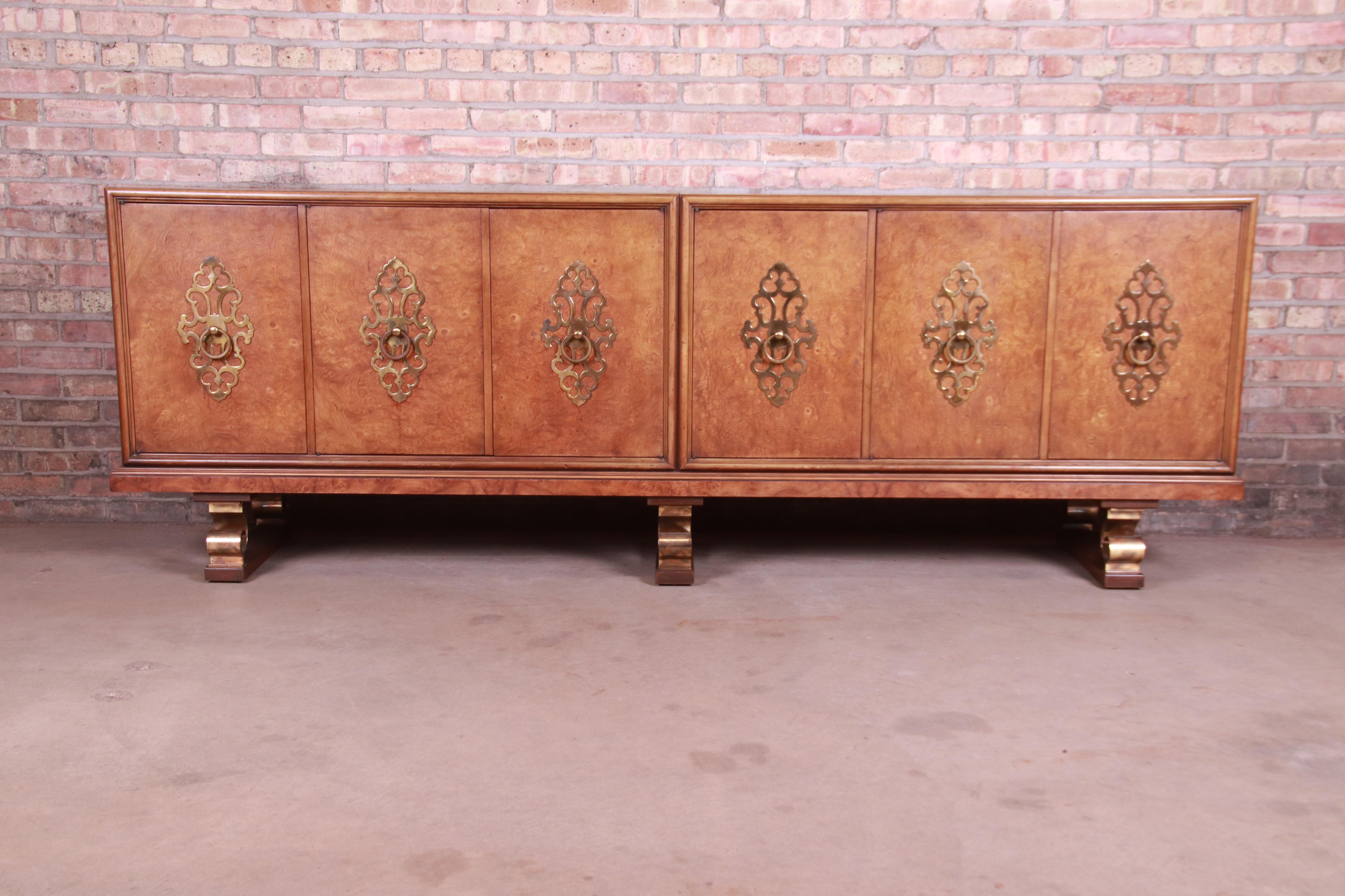 A gorgeous monumental Mid-Century Modern Hollywood Regency sideboard, credenza, or bar cabinet

By Mastercraft,

USA, circa 1960s

Burled olive wood face, with fruitwood case, original brass hardware, and scrolled brass legs.

Measures: