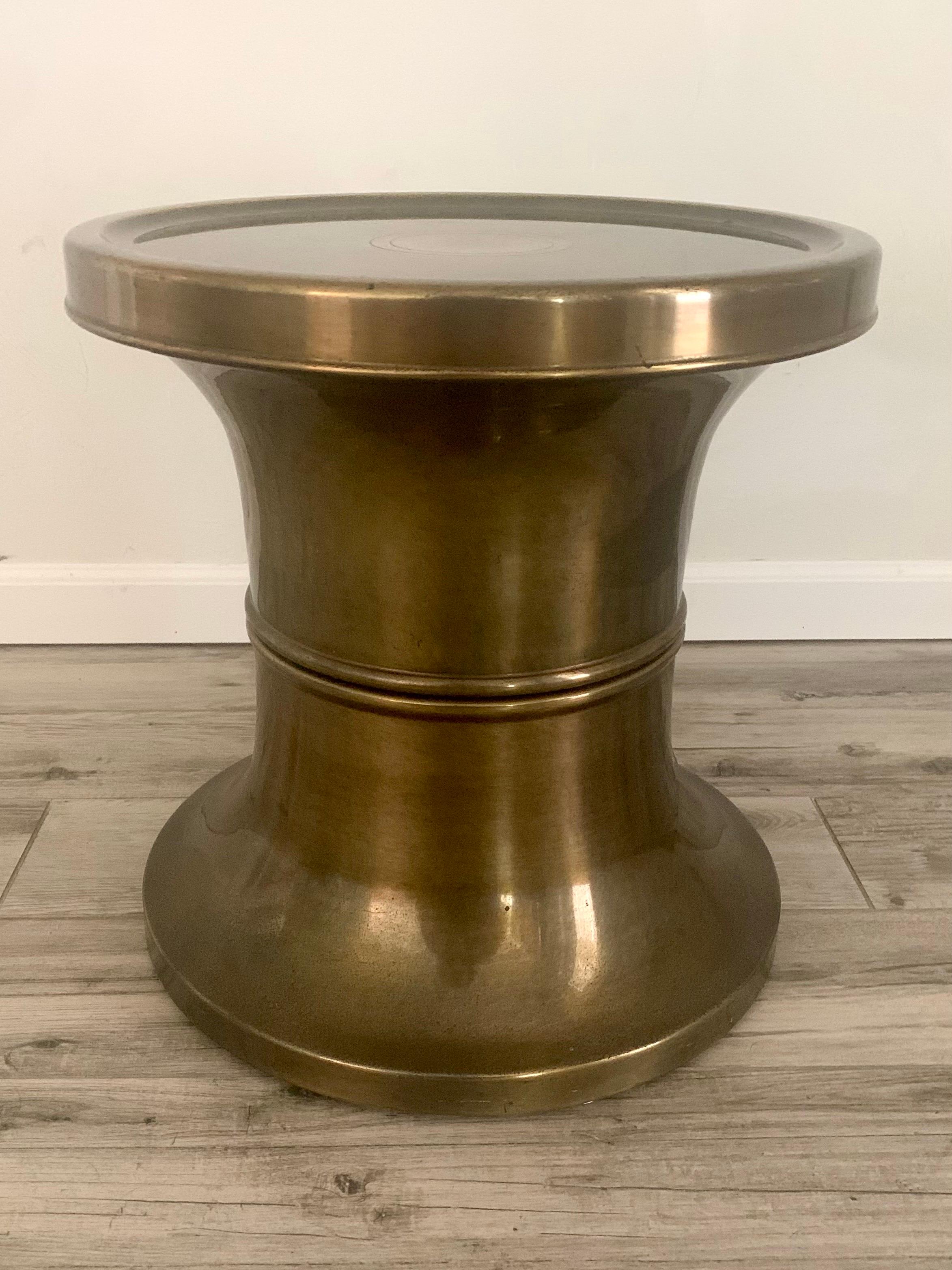 Side table by Mastercraft in brass. Has an antiqued bronze finish that has aged beautifully. It is a lacquered finish. 

Small signs of wear and tasteful patina denoting the age of this piece. 

Has a very high quality build and could be used as a
