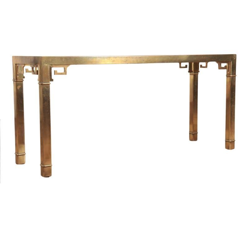 A Mastercraft  style console table with brass frame and beveled glass top.  The table legs and apron have an Asian fretwork motif that is characteristic of Mastercraft design. A mid-century chic addition to a room.