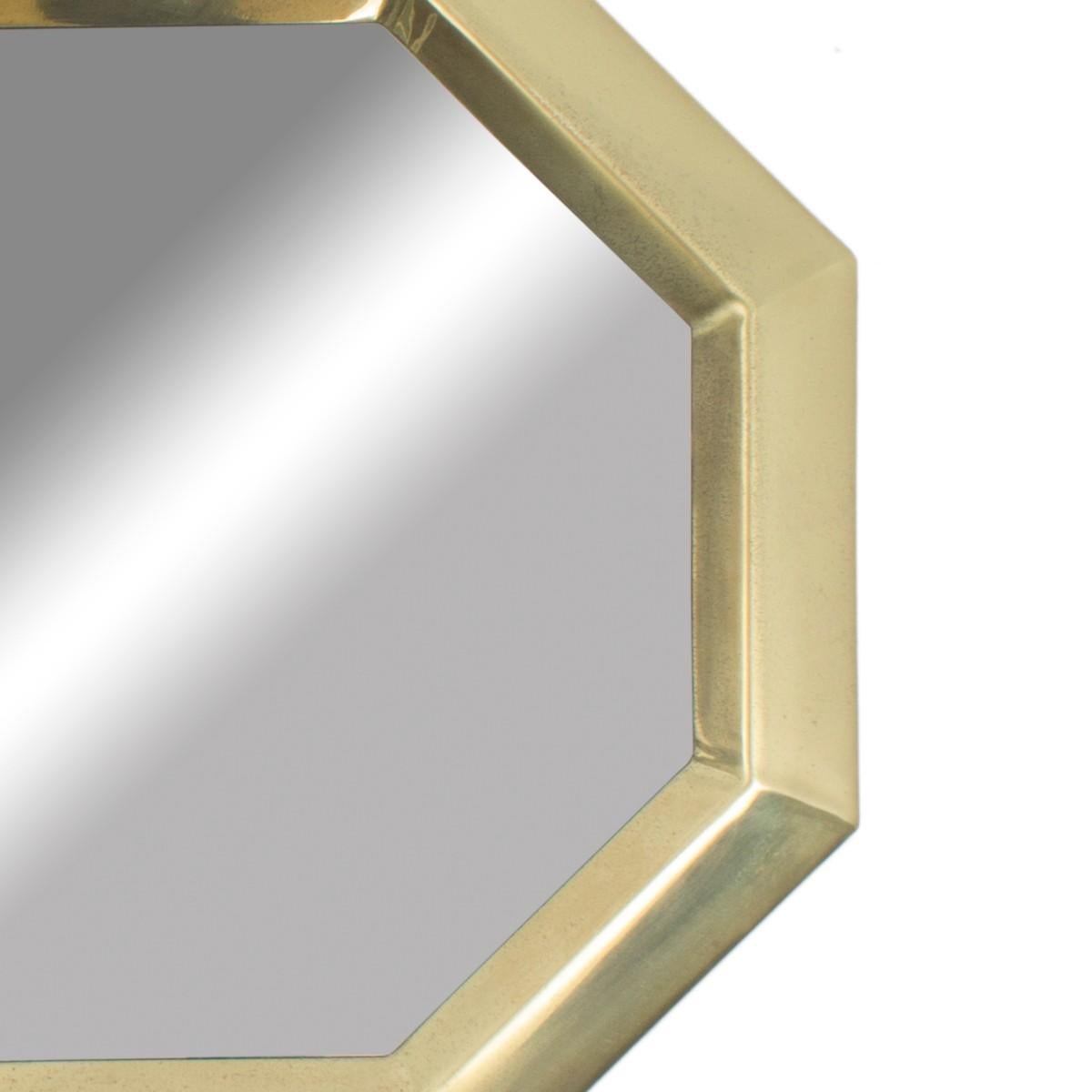 A brass hexagonal-shaped wall mirror in the style f Mastercraft. Imported, circa 2000.