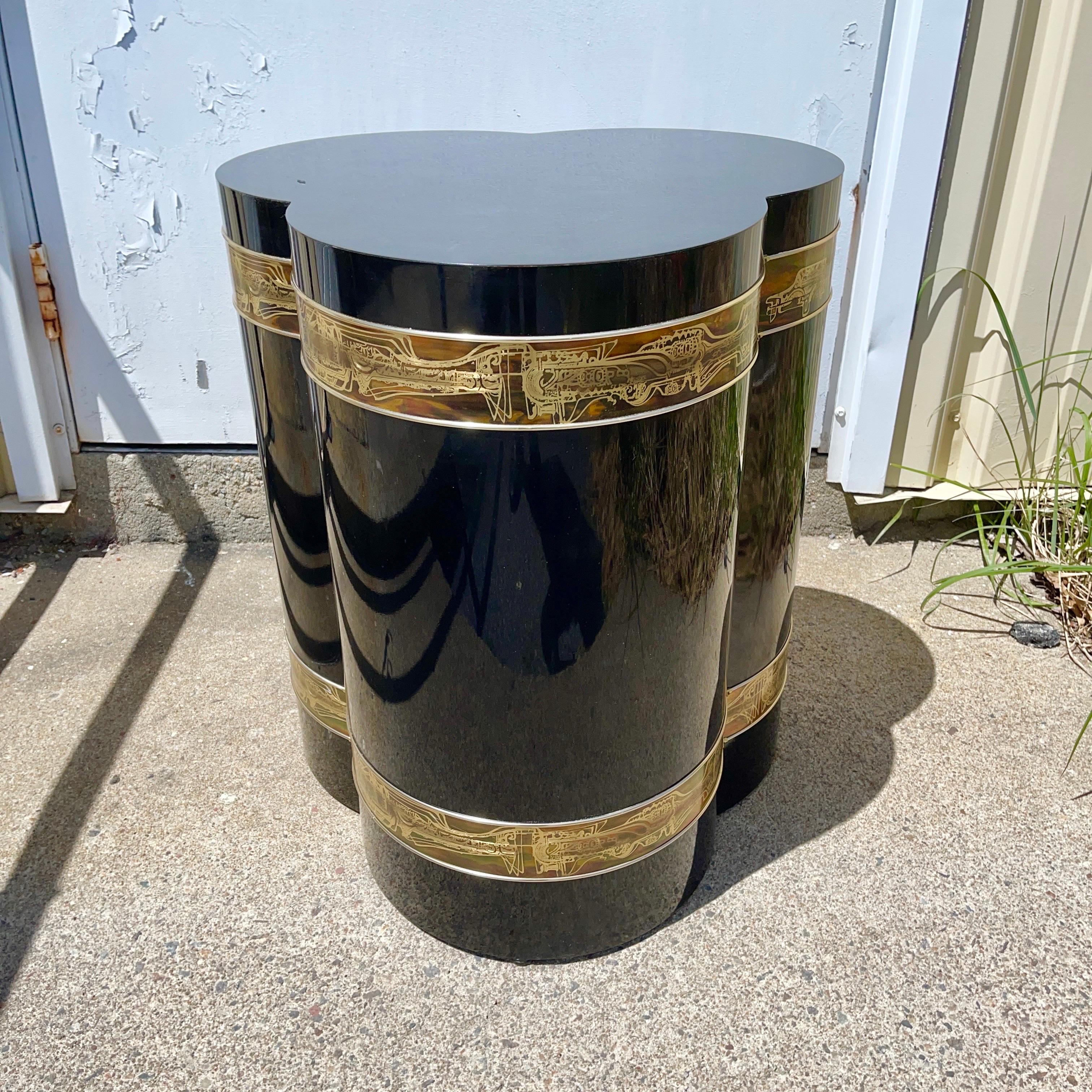 Mastercraft Furniture model 1611 lamp table in trefoil form in high luster black lacquered wood double banded by acid etched brass art metal by sculptor Bernhard Rohne. 24” high by 21” diameter. 


 