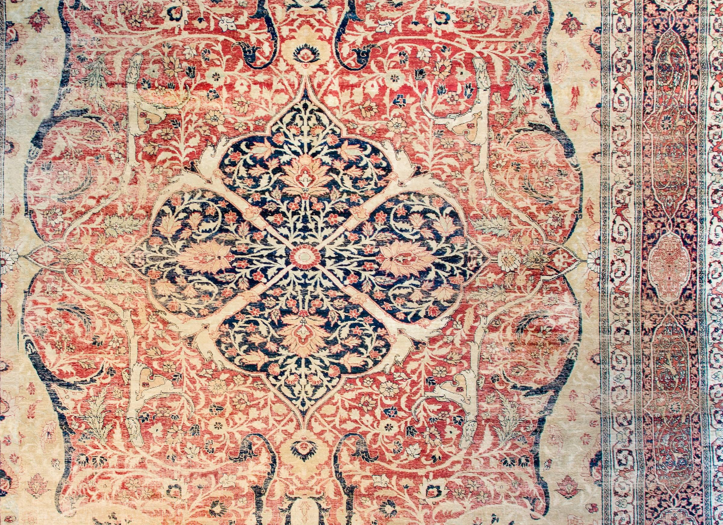 A truly masterful mid-19th century Persian Haji Jalili Tabriz rug with an amazing design. The central medallion is skillfully rendered with scrolling vines with myriad multicolored flowers. The medallion rests on an incredible field of similar