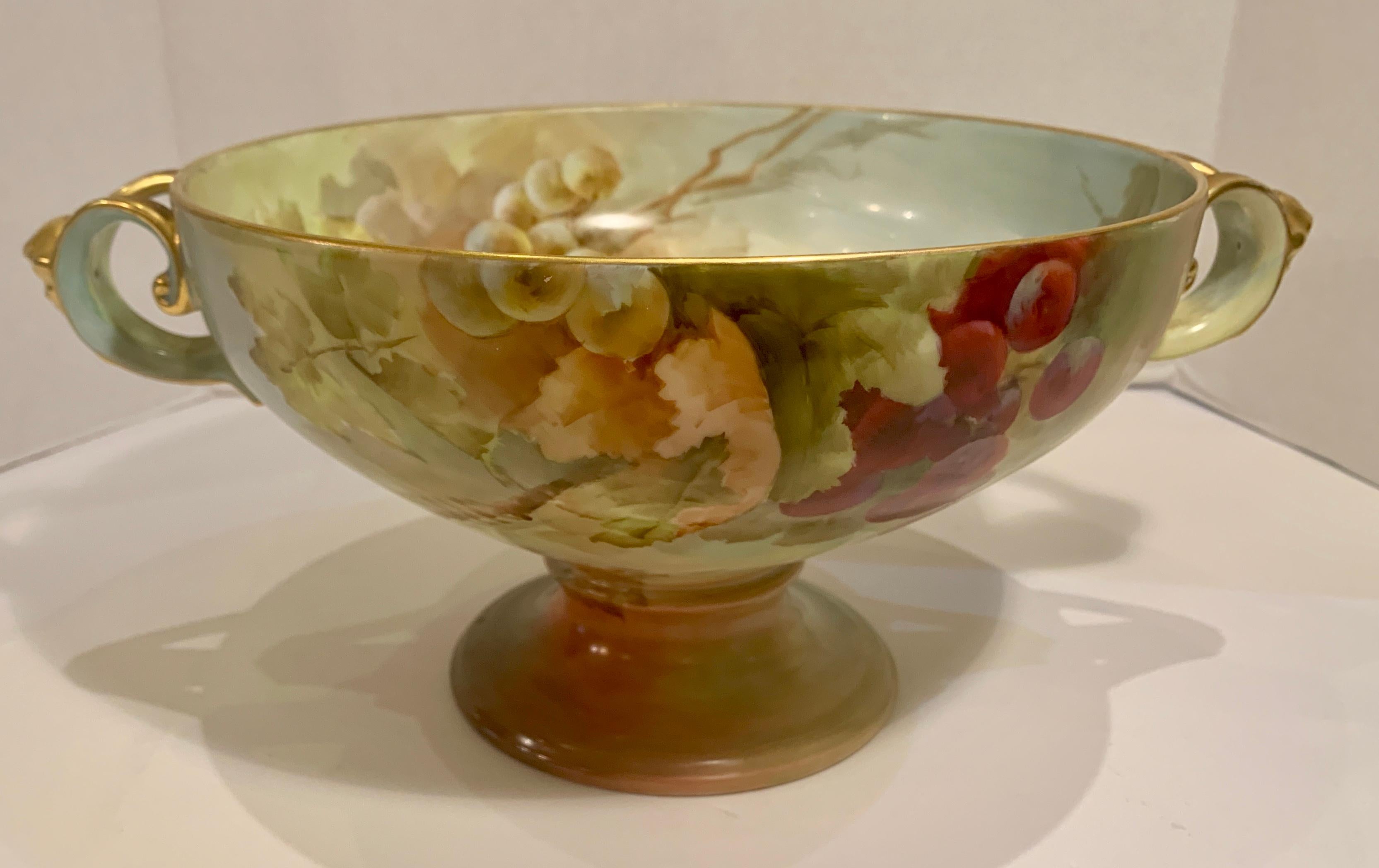 Exquisite large antique fine porcelain Art Nouveau Philipp Rosenthal Bavarian “Empire” pedestal footed centerpiece bowl is from the early 1900s. Bowl is lavishly hand painted inside and outside with magnificent, colorful and very realistic clusters