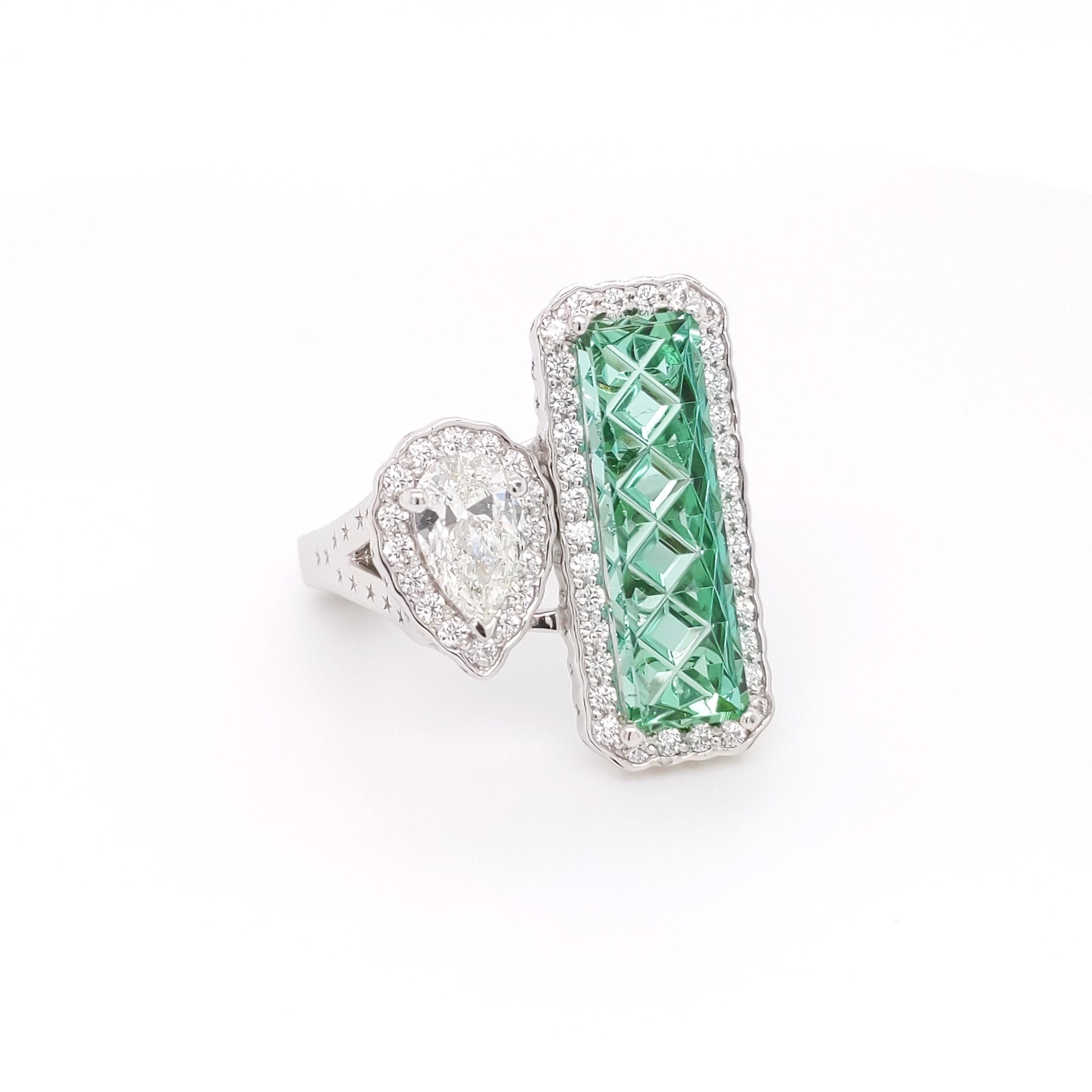 One of a kind Custom by a collaboration of top talent. 1st the design is by Erica Sanchez-Hawkins, an award winning designer, the Tourmaline was made by an multi-award winning lapidary and the diamonds by one of the finest diamond cutters in the