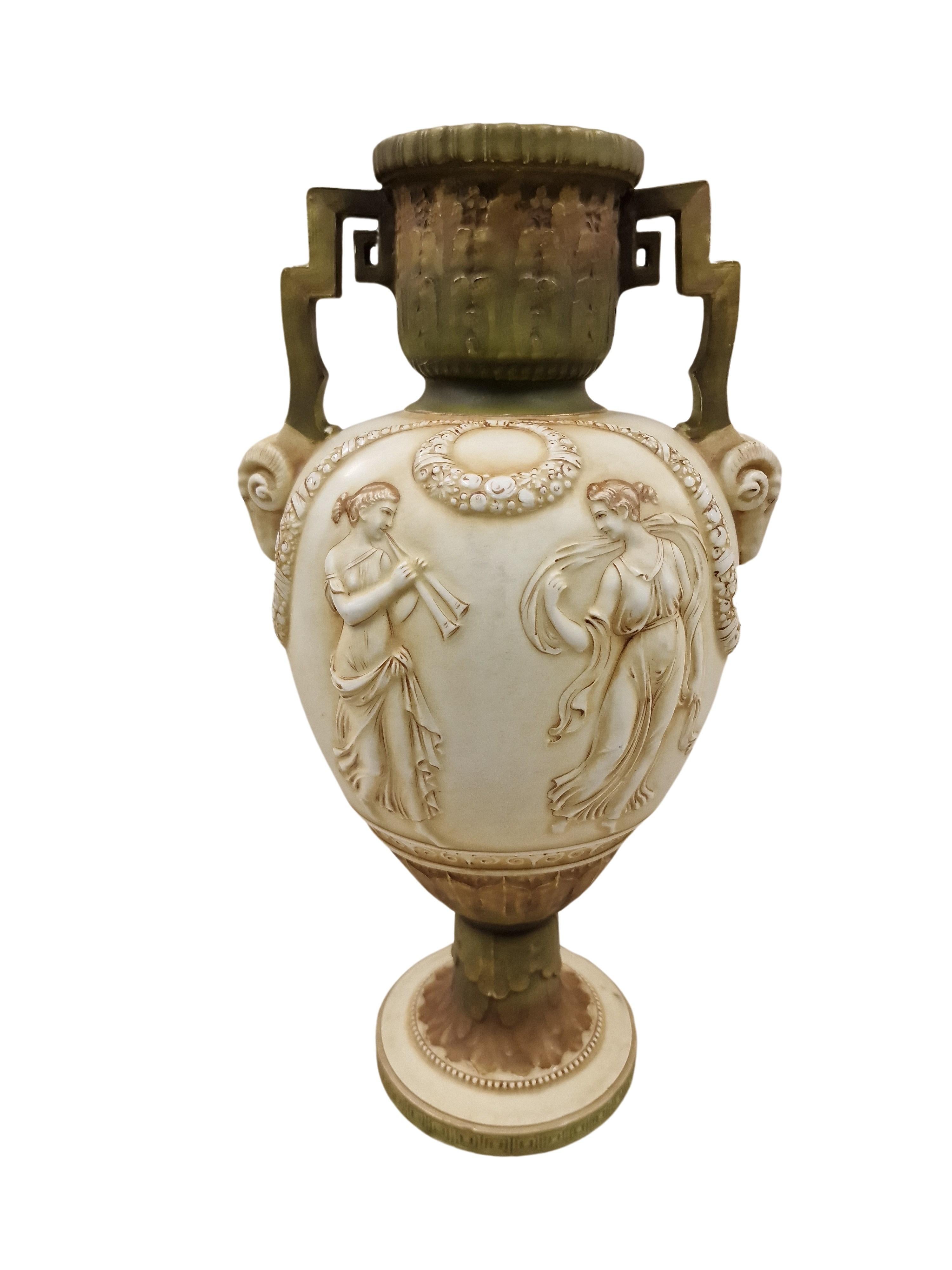 This stunning vase was made by Royal Vienna Porcelain, with support from Ernst Wahliss (1837 - 1900). The vase is in amphora shape, hand painted and has the early mark on the underside.

The porcelain vase is ivory colored with light green and brown