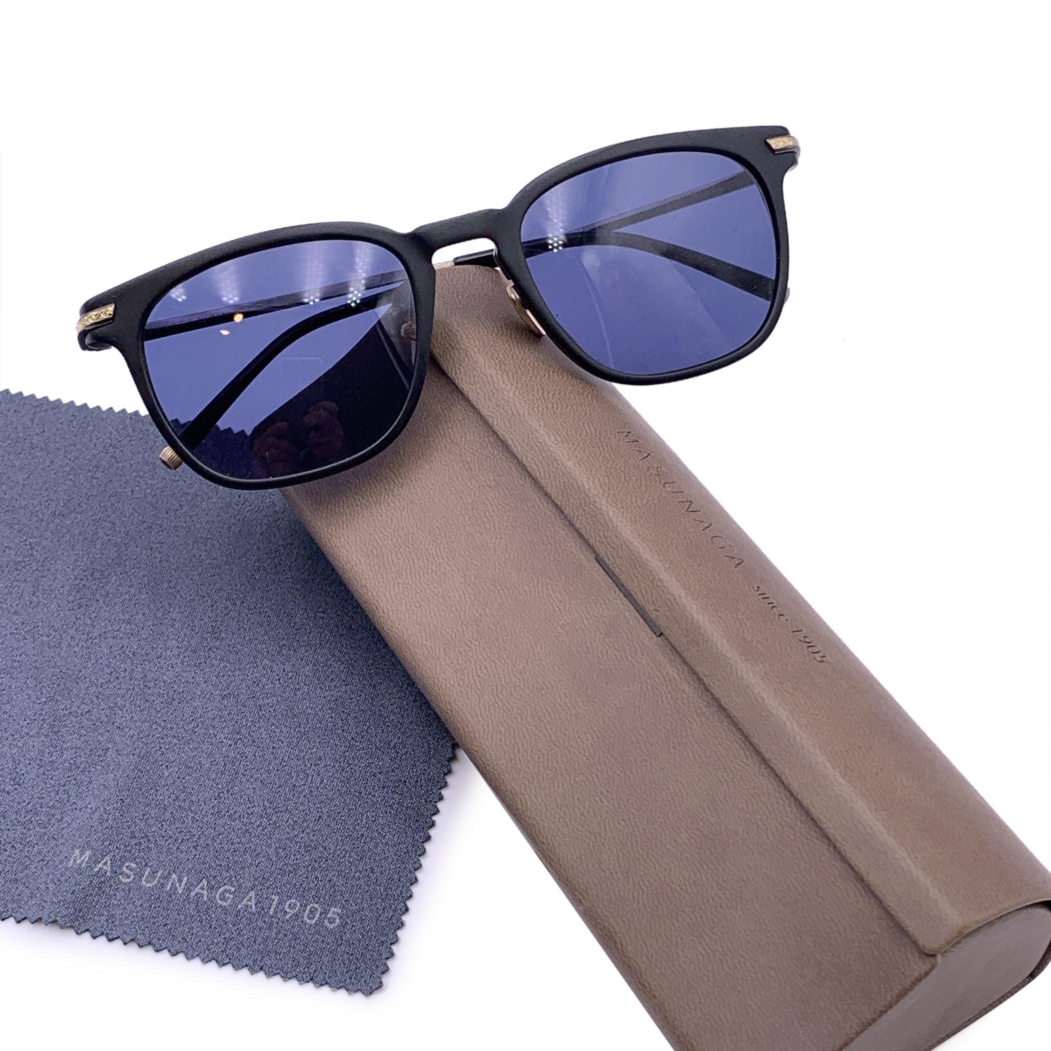 Masunaga 'Rigel' Sunglasses. Black acetate frame with titanium temples . Vintage inspired square shape. Beautiful arabesque details on the ear stems. Original blue lenses. Style and Refs: 52/21 - 140 - Handmade in Japan. Reatil prise is approx. 596