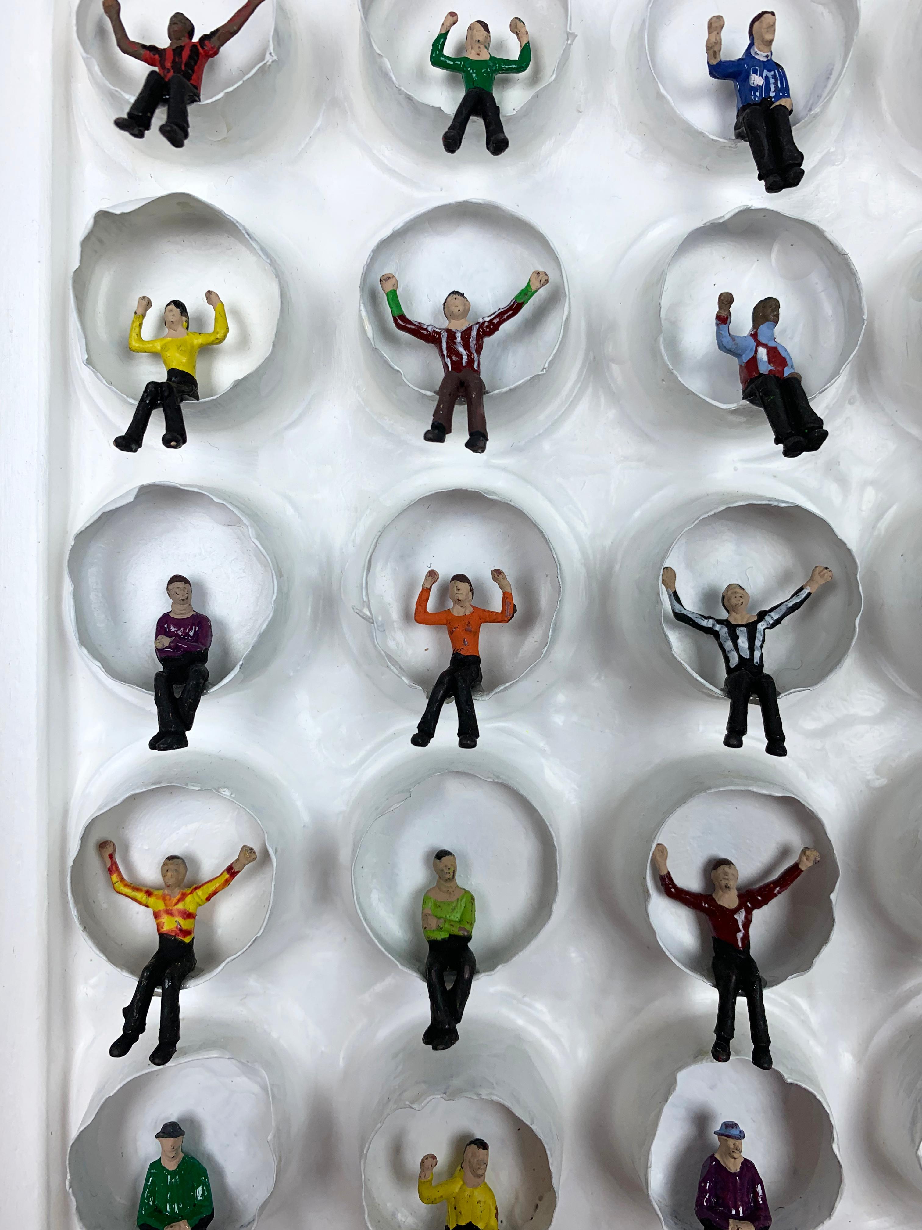 Celebrate by Mat Kemp, 2019

Created using recycled Nespresso capsules, Subbuteo figures, acrylic paint, marbles and wood.

Mat Kemp is an English artist with an outstanding academic background:
 
School of Communication Arts 1990.
Royal College of
