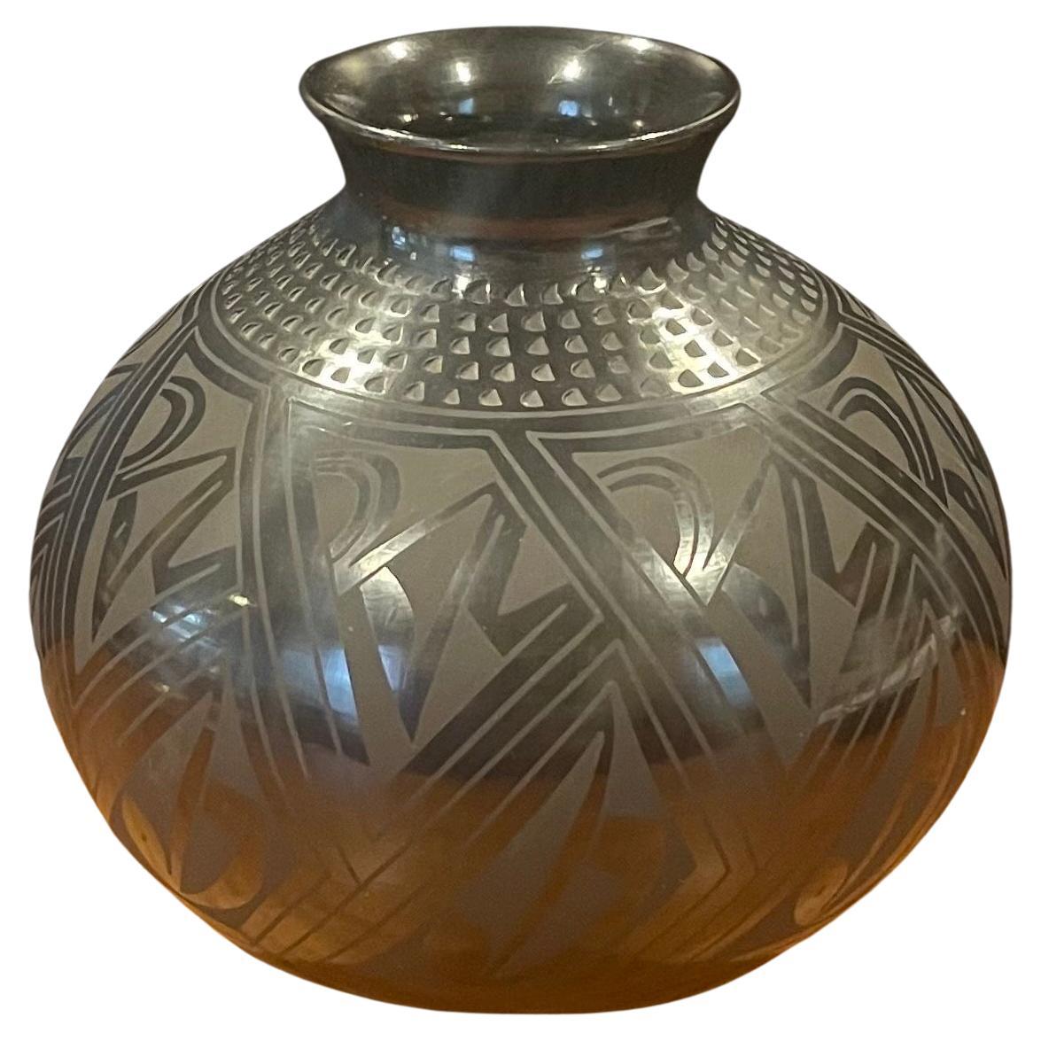 Beautiful hand-turned geometric blackware vase by Tomaso Mora, circa 1990s. The exquisite piece made of naturally black clay has a unique geometric design. This vase is in very good condition and measures 6