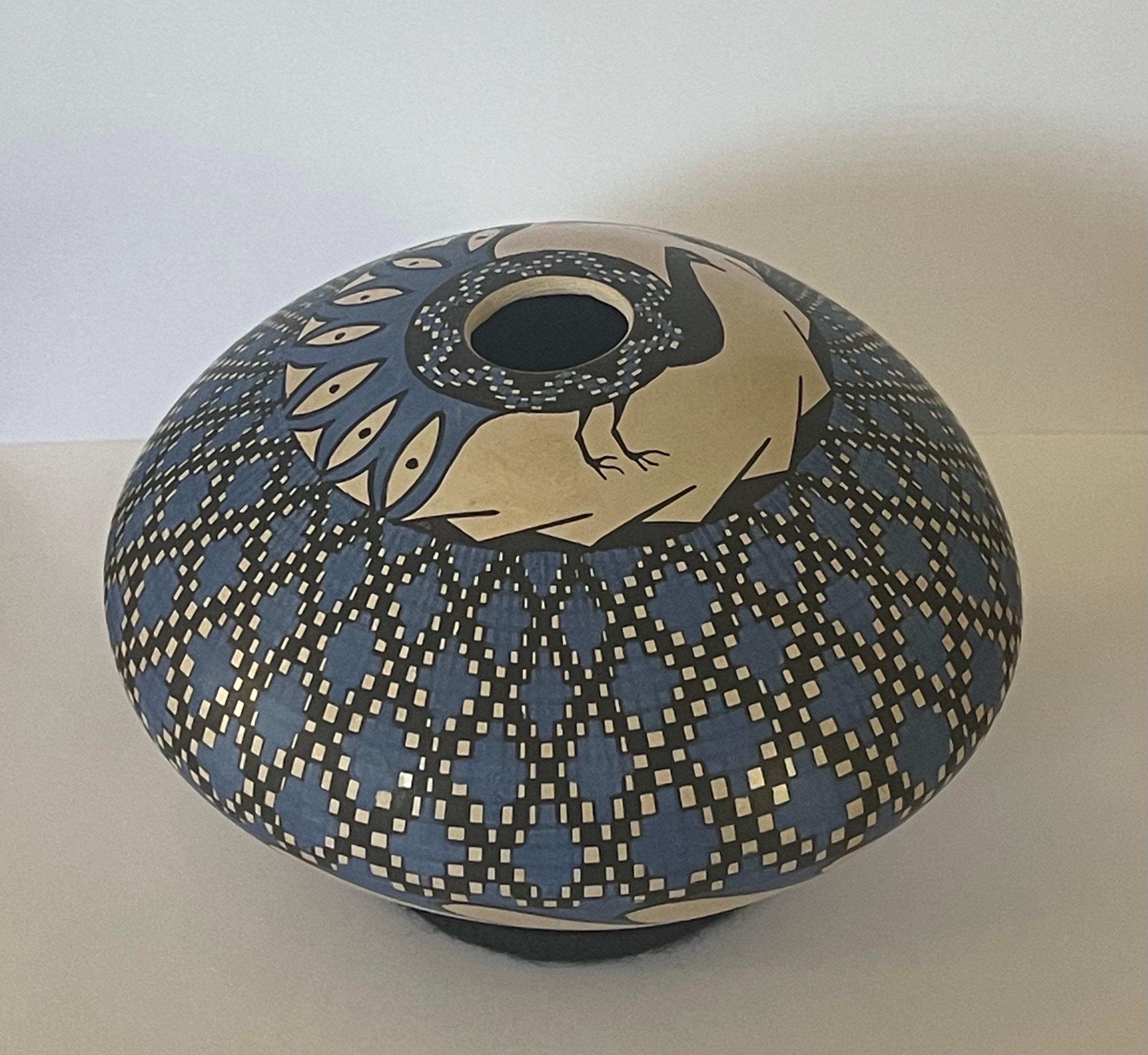 Beautiful hand-turned polychrome Mata Ortiz geometric vase by Emila Villa, circa 1990s. The vase has a beautiful blue finish woth a peacock as the center piece and measures 5