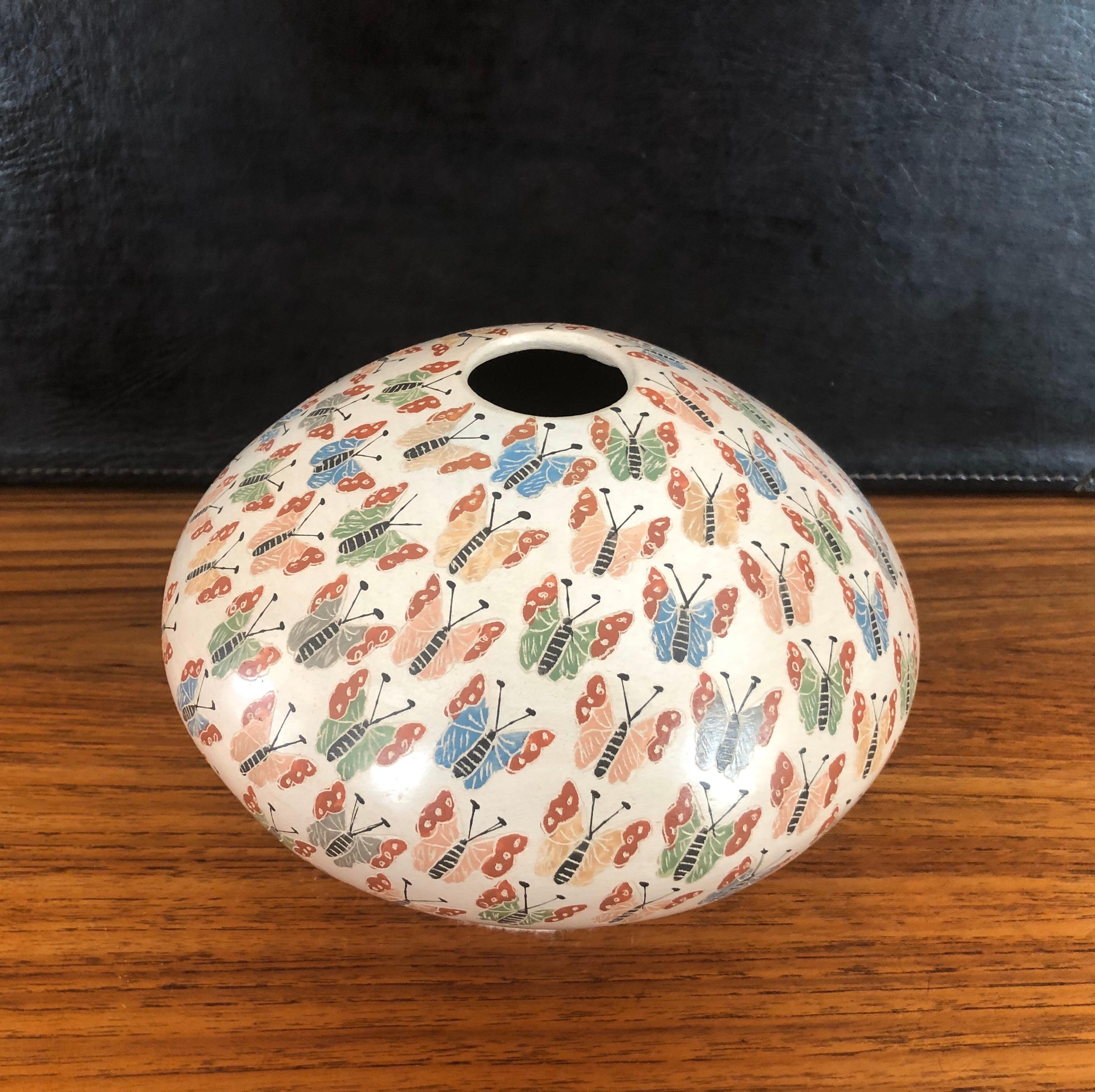 Beautiful hand-turned polychrome Mata Ortiz butterflies vase / seed jar by Celia Lopez, circa 1990s. The exquisite piece has wonderful design and color. 

Mata Ortiz or Casas Grandes pottery comes from the small village of Mata Ortiz located near