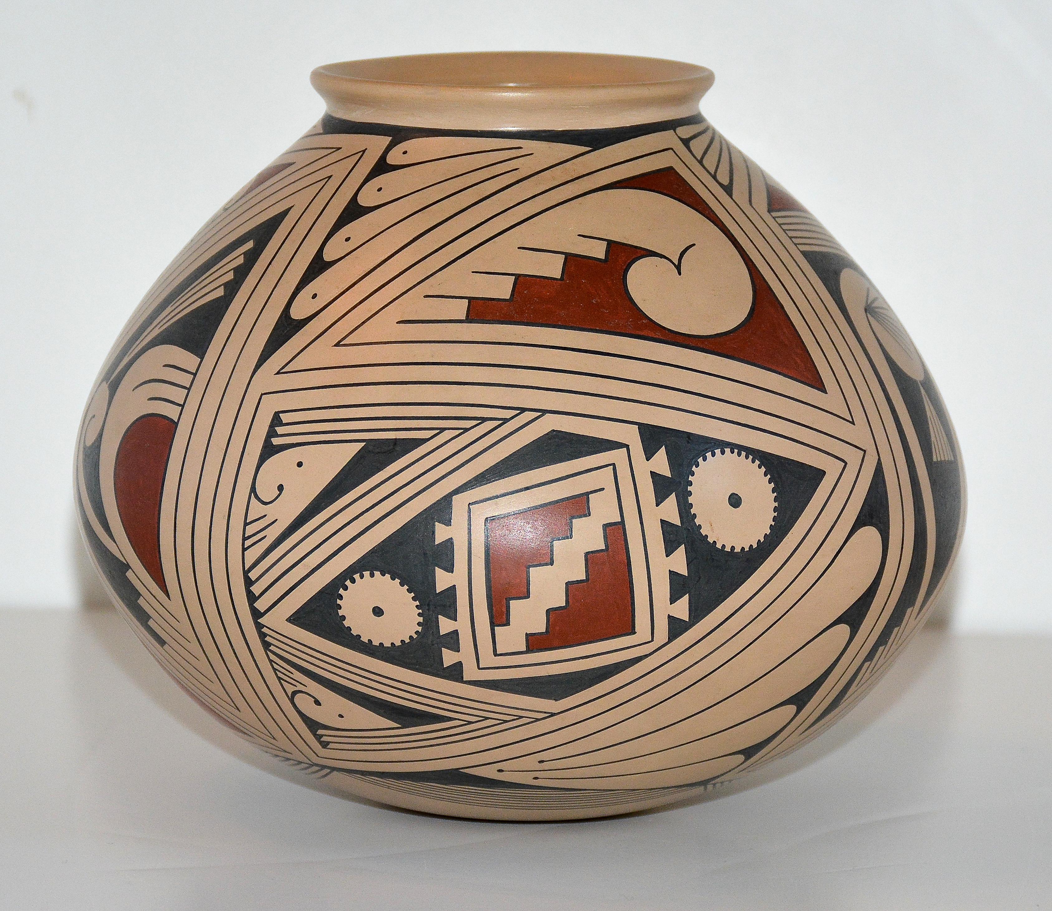 Mata Ortiz Polychrome Pottery vessel
Pilo Mora, Master Potter (1961 - )
1990
Hand coiled low fire clay
Pueblo Quezada, Mata Ortiz, Chihuahua, Mexico
7 inches H. x 7.5 inches in Diameter

A classic example of this Master Potter's early work appearing