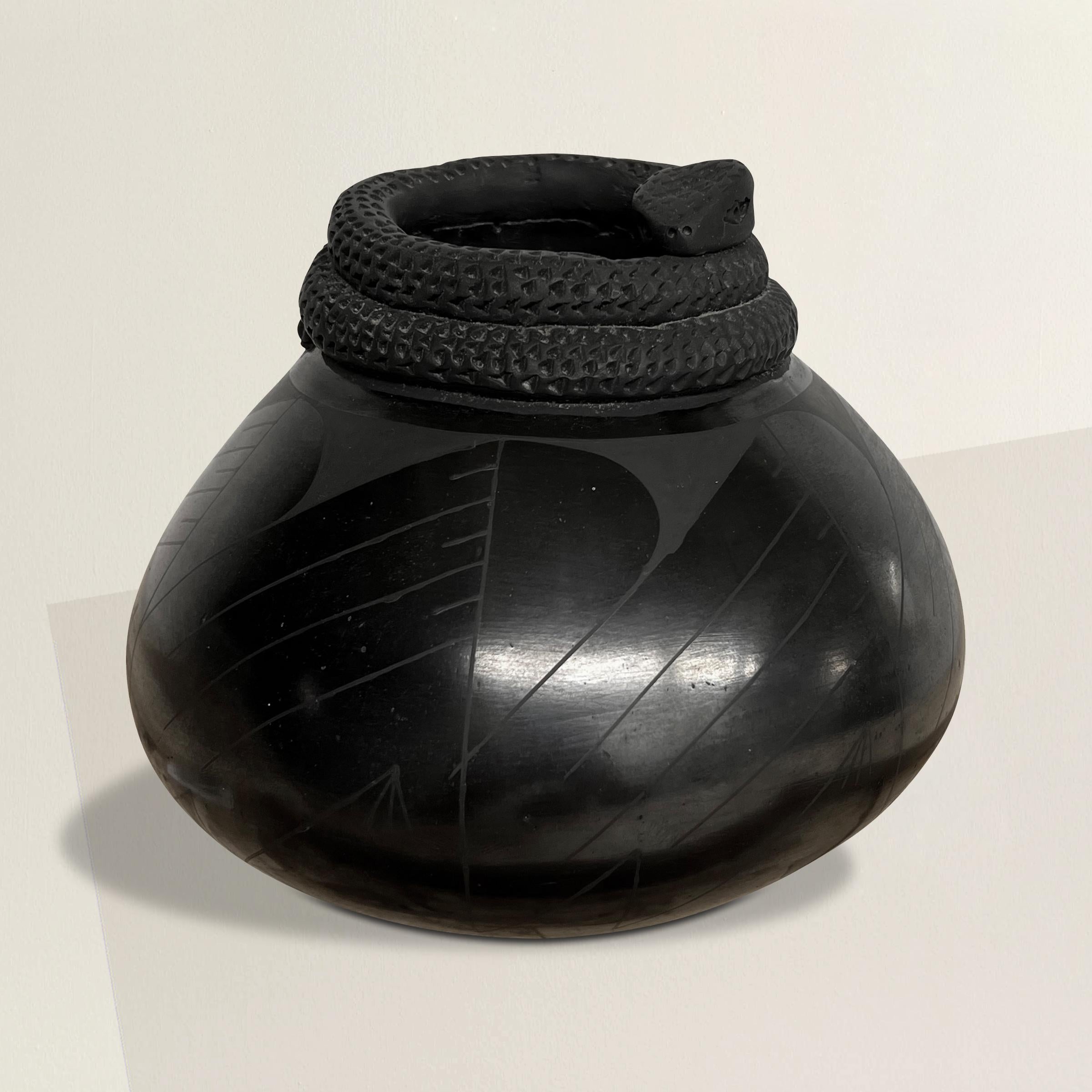 A chic and sinister Mata Ortiz ceramic pot with the most wonderful coiled snake effigy surrounding the lip and a beautiful burnished finish.