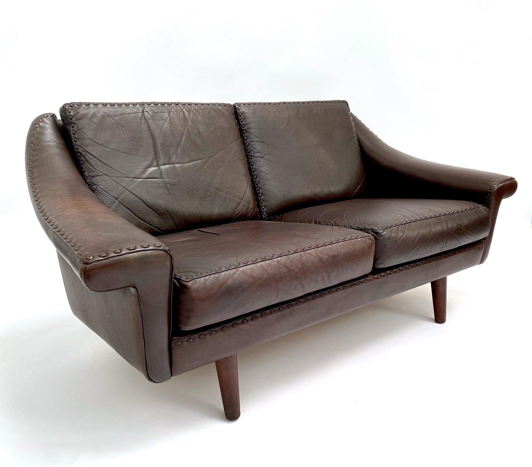 A beautiful Danish dark brown leather ‘Matador’ two seater sofa designed by Aage Christiansen for Erhardsen & Andersen, this would make a stylish addition to any living or work area.

The sofa has a wide seat and padded armrests for enhanced