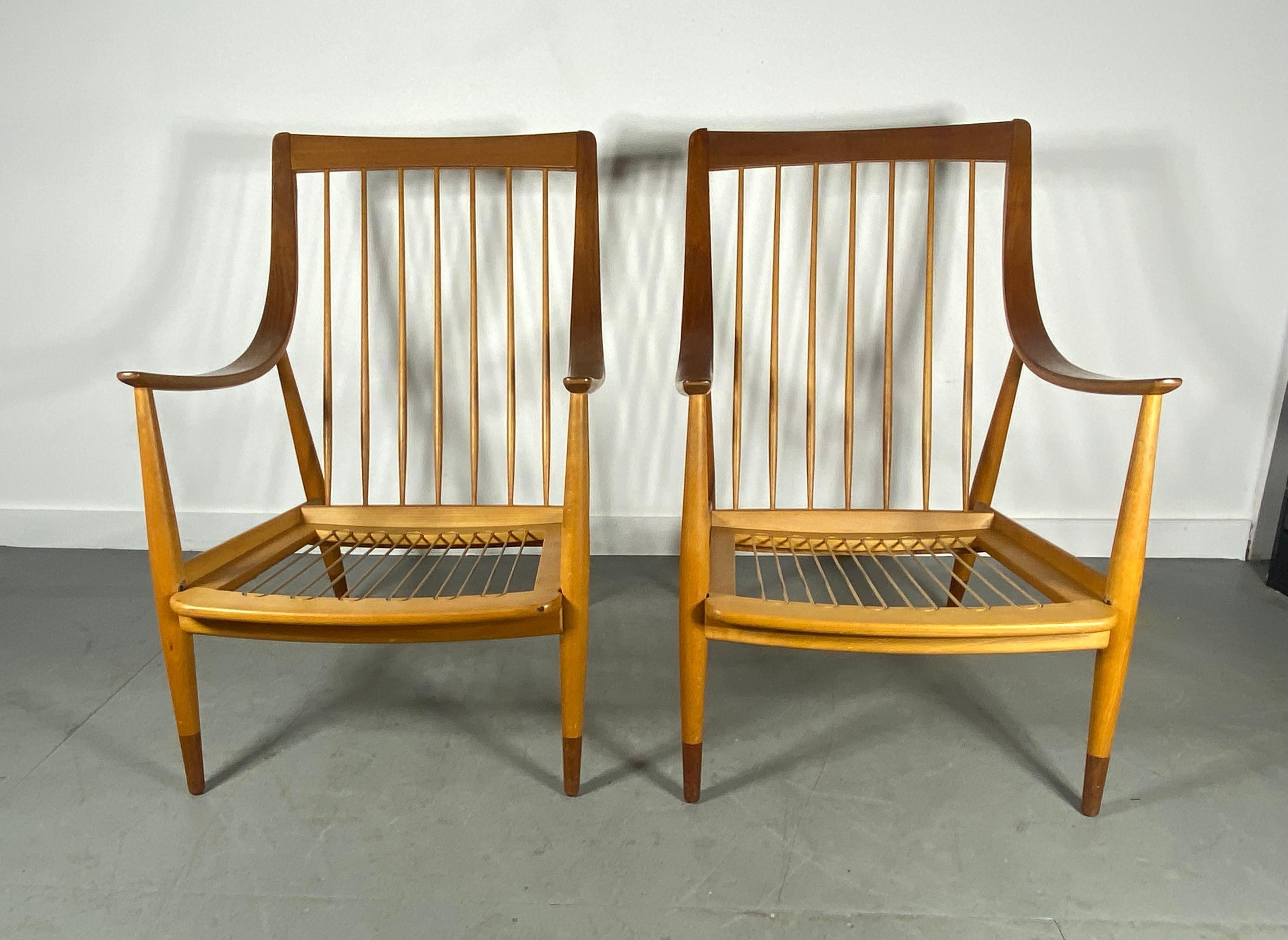 Beautiful Pair of Peter Hvidt & Orla Mølgaard-Nielsen easy chairs for France & Daverkosen made in Denmark, circa 1950s. This stunning chair was designed with the highest quality of teak. The chair features laminated bentwood curvilinear arms and