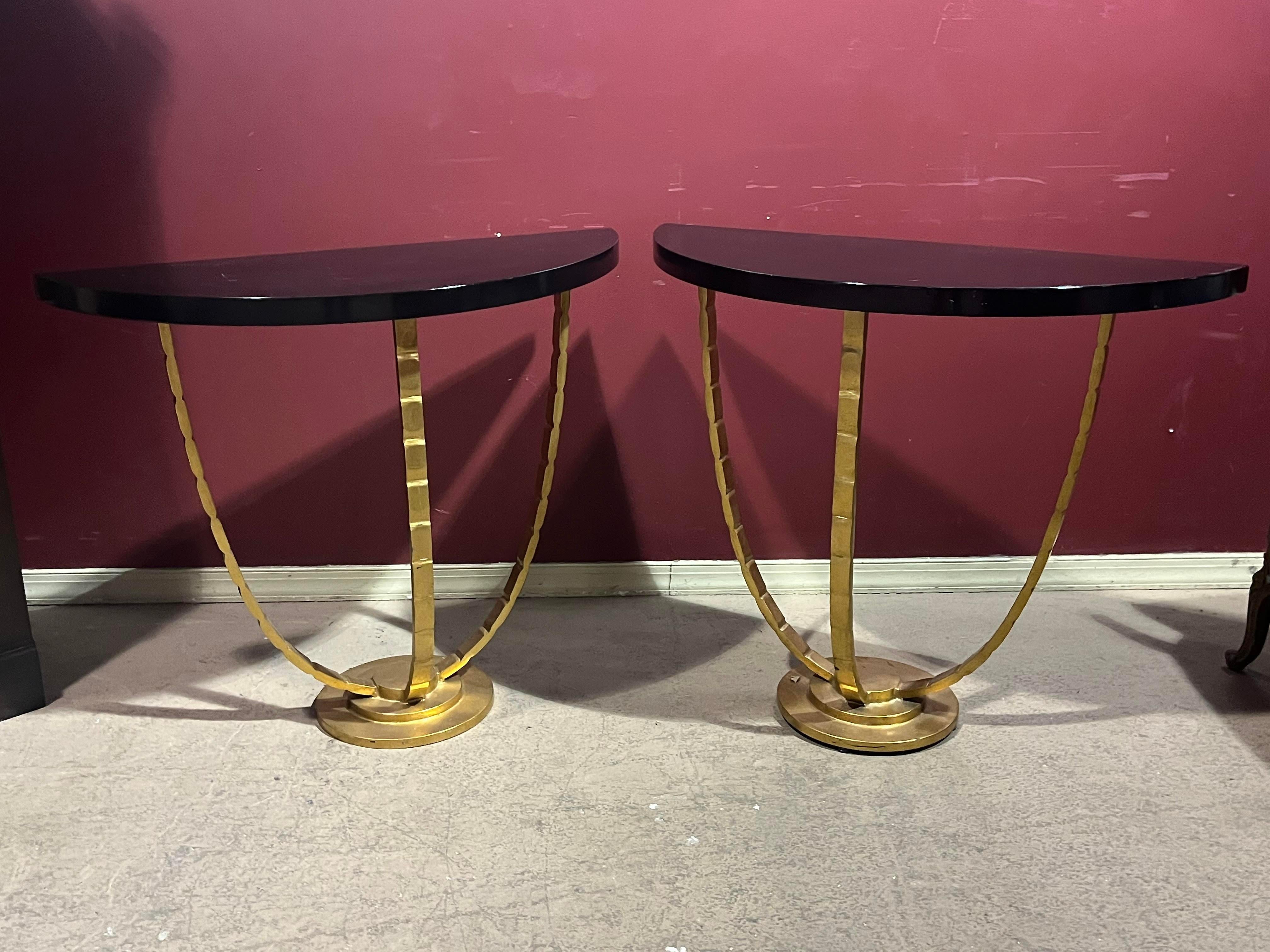This is a beautiful pair of French art deco style gilded steel and wood console tables. The tables are finished in gold leaf and incredibly elegant and sophisticated. The table tops could be fitted with marble or faux painted in any finish. They