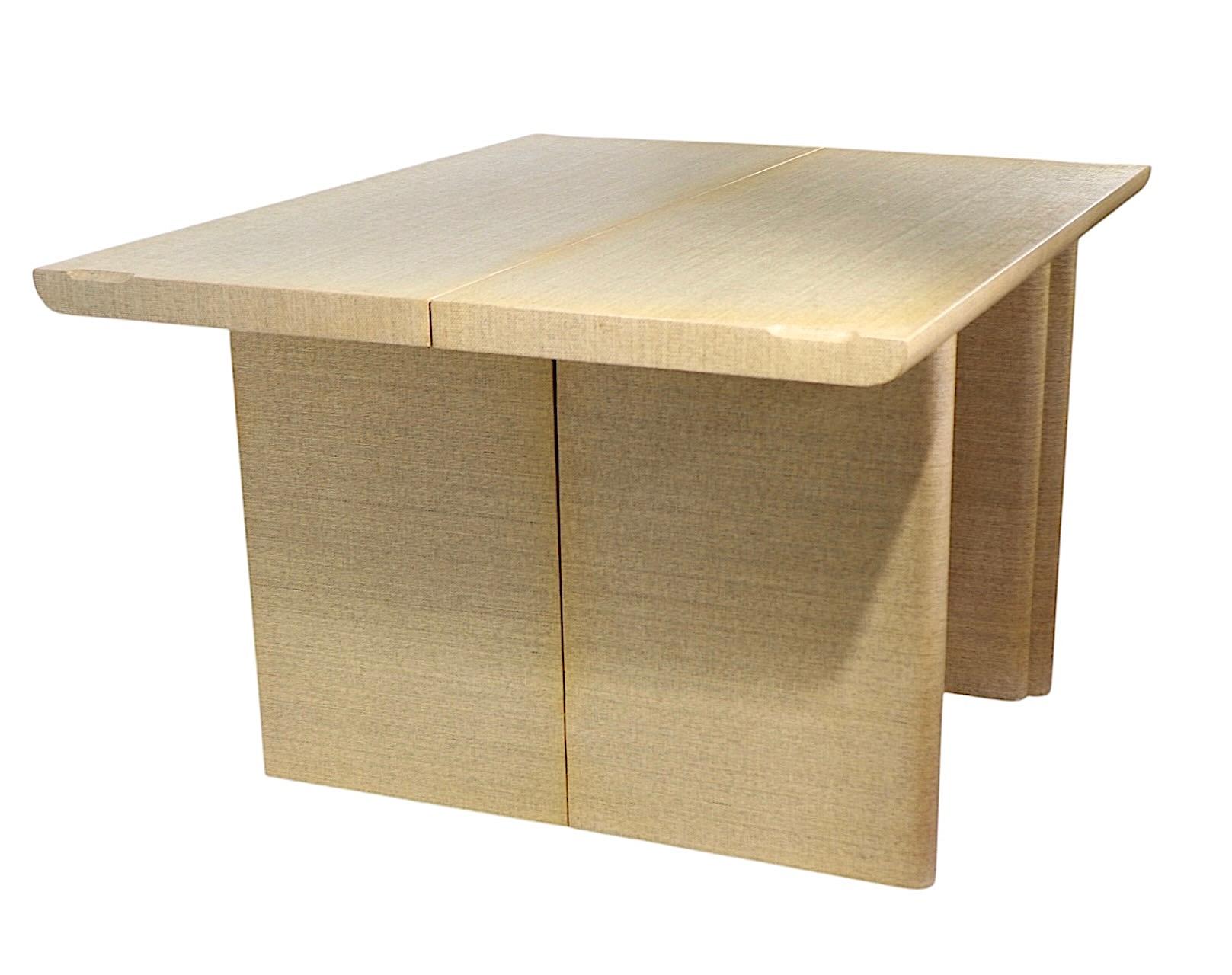    Exceptional match pair of grass cloth flip top console dining tables, in very fine, original, clean and ready to use condition. The tables feature tops which flip open, the bases fold open to create a functional and  stylish dining table. 
 Well