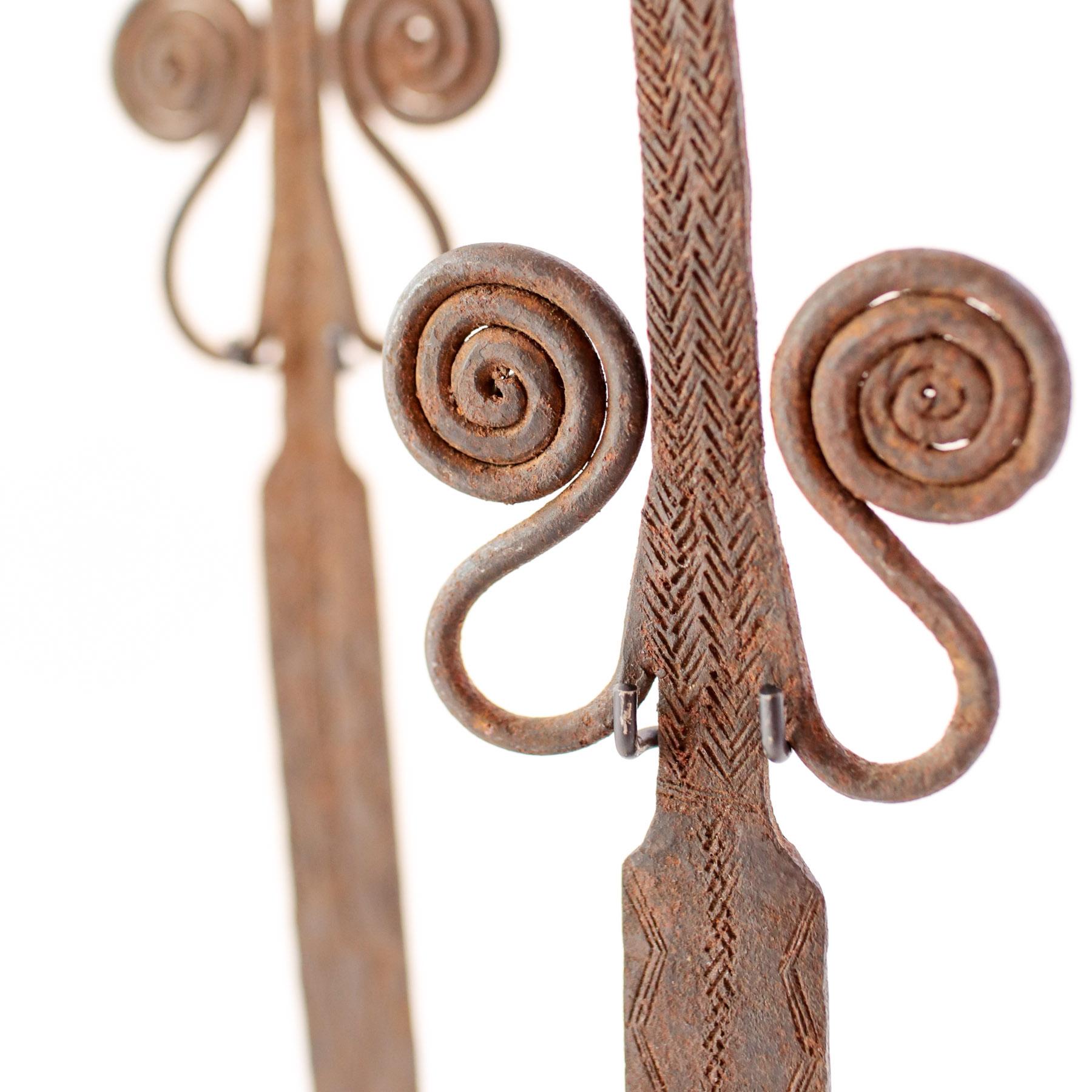 This is a matched pair of forged iron currencies from the Mumuye Tribe of Nigeria. The currency is in the rare form of figural spoons. Pre-1900. Displayed on custom metal stands. 

African Currency encompasses a variety of metal objects used in