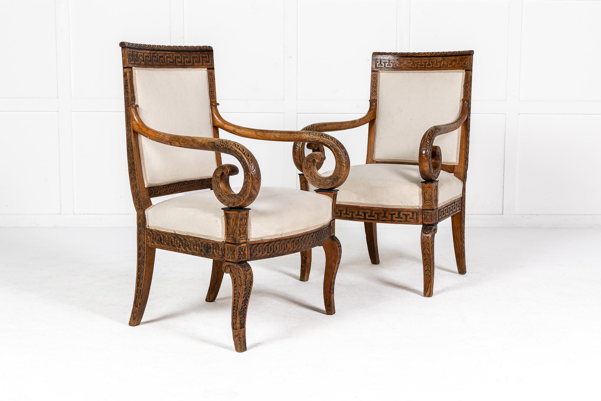 An exceptional, rare pair of 19th Century French, beautifully and profusely carved wood chairs, matched with similar decorative and intricate detail. The top rails having the same geometric design with ebony detail that repeats under the arms and