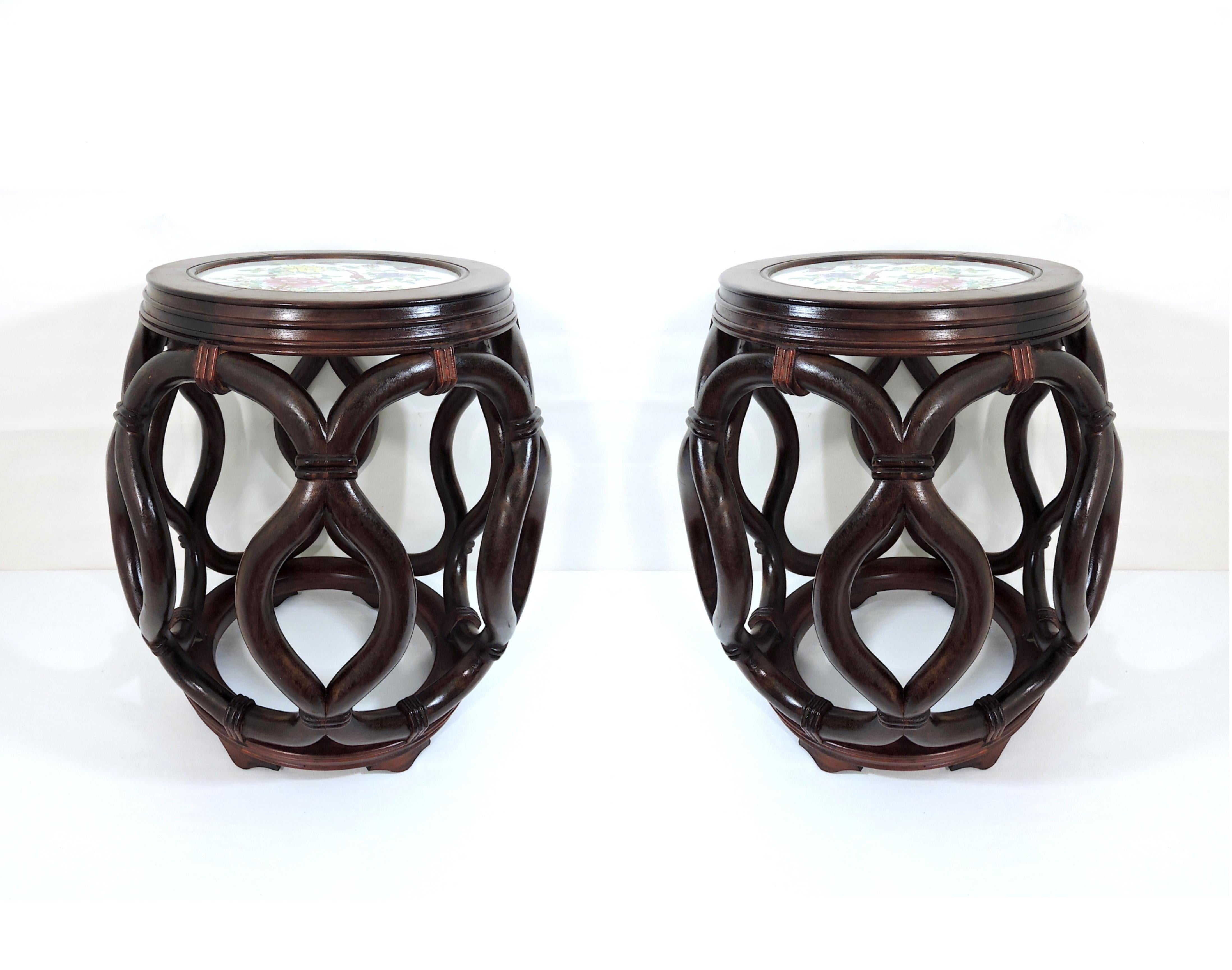 A matched pair of antique Asian carved perfectly symmetrical rosewood barrel stools, late 19th-early 20th century. Each handmade stool features a circular form with carved open-work rope simulated frame ties on a circular base raised on four short