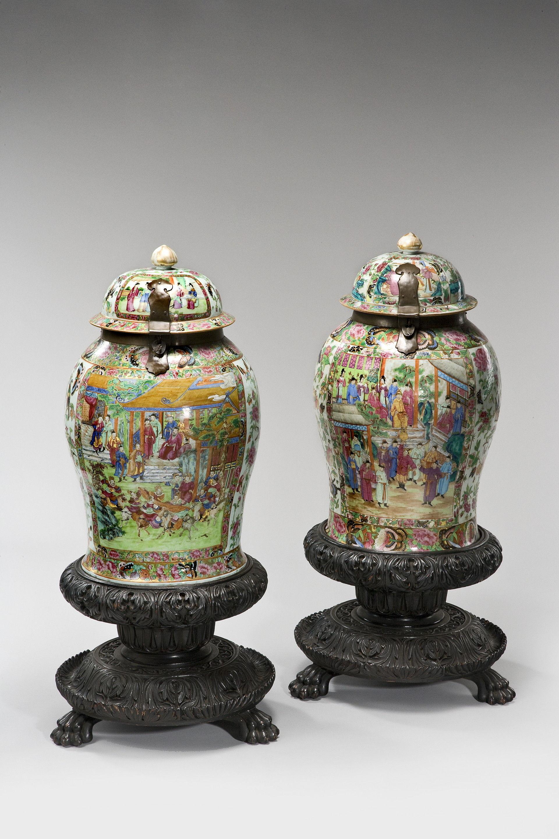 Matched pair of Cantonese enameled porcelain standing jar. On original hardwood bases.