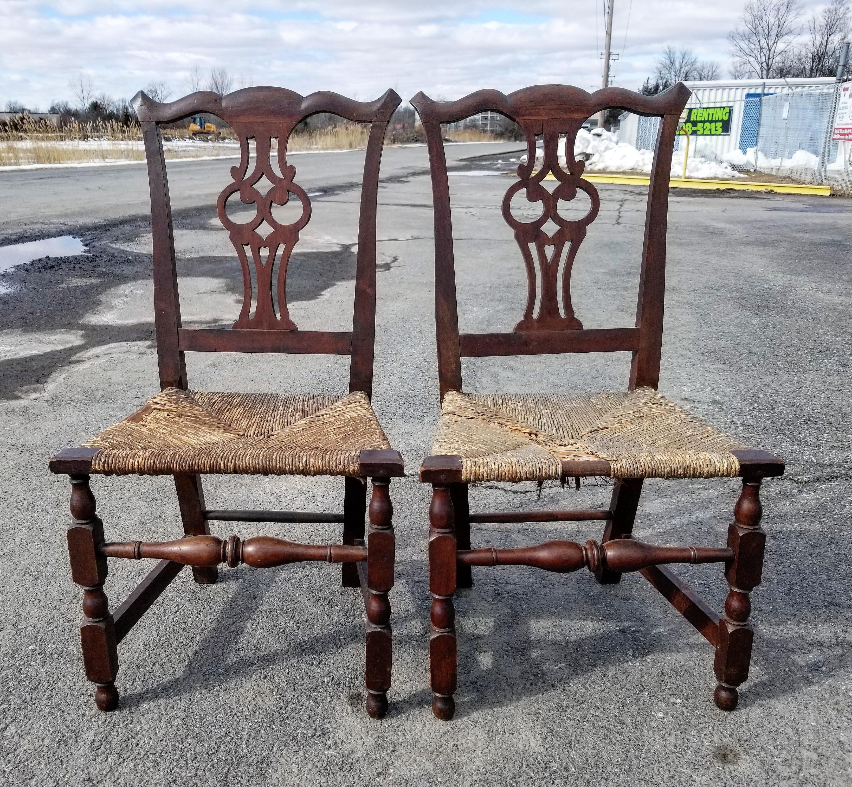 Beautiful pair of American Chippendale side chairs in with original surface and rush Seats. Likely from Salem Massachusetts these chairs display tight serpentine crests with upswept ears above owl splats flanked by swept stiles; trapezoidal seats