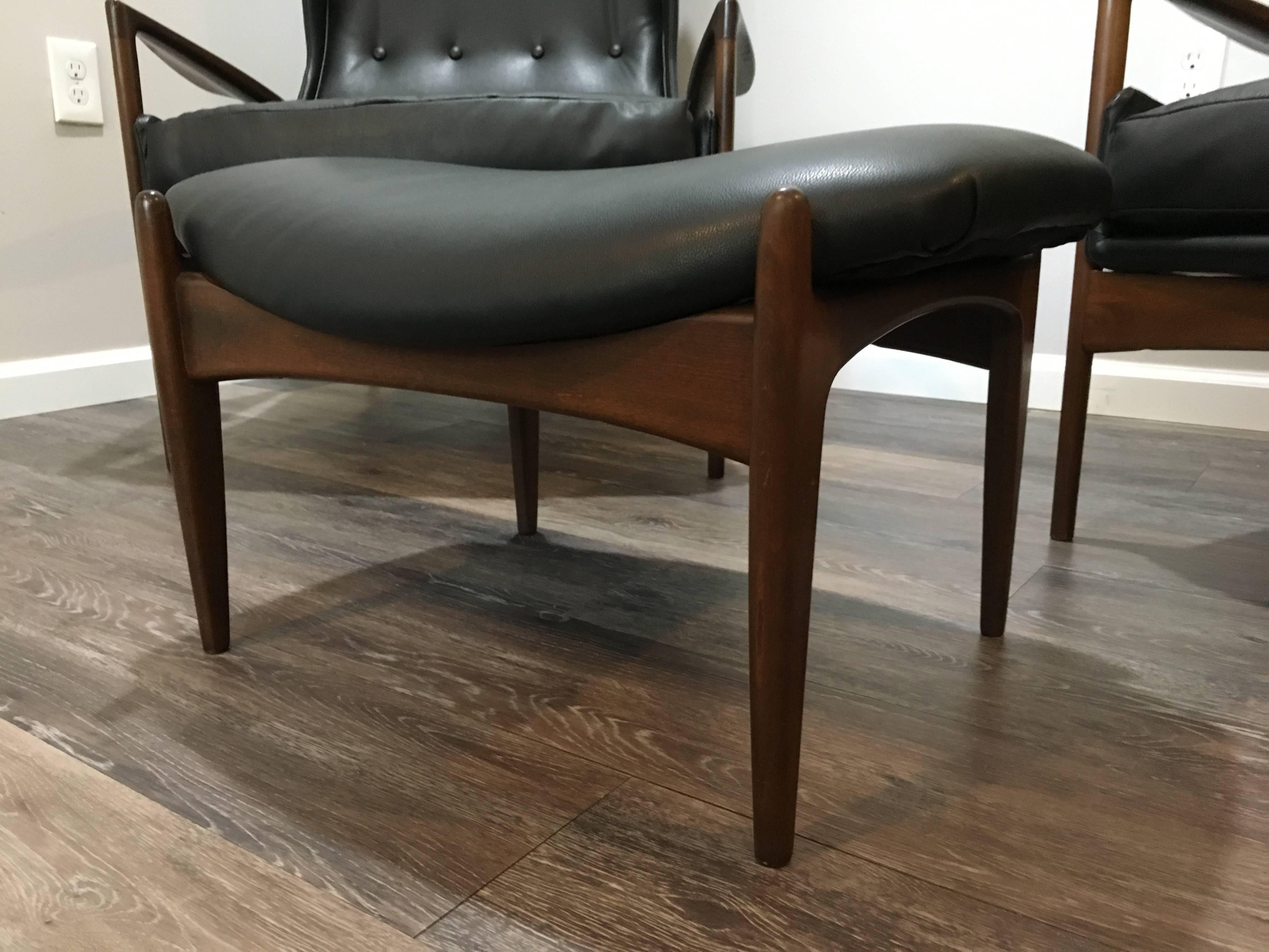 Mid-20th Century Matched Pair of Kofod Larsen Leather Wingback Chairs and Ottoman